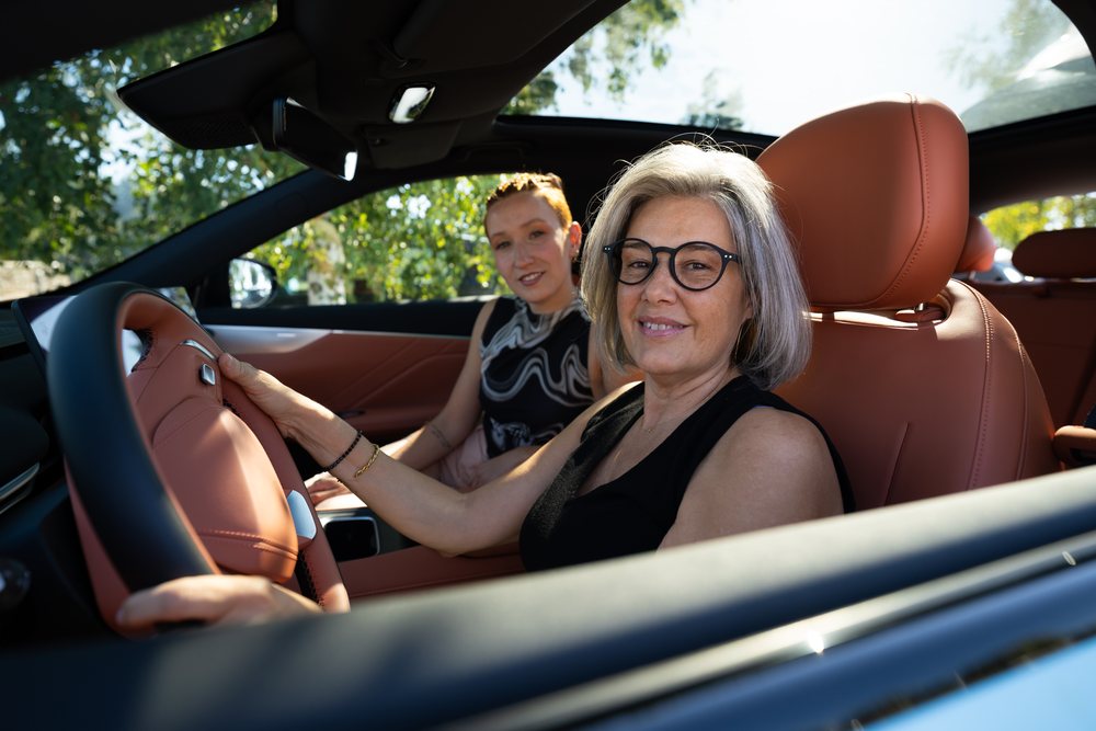 Two white women inside car with one driving and passenger