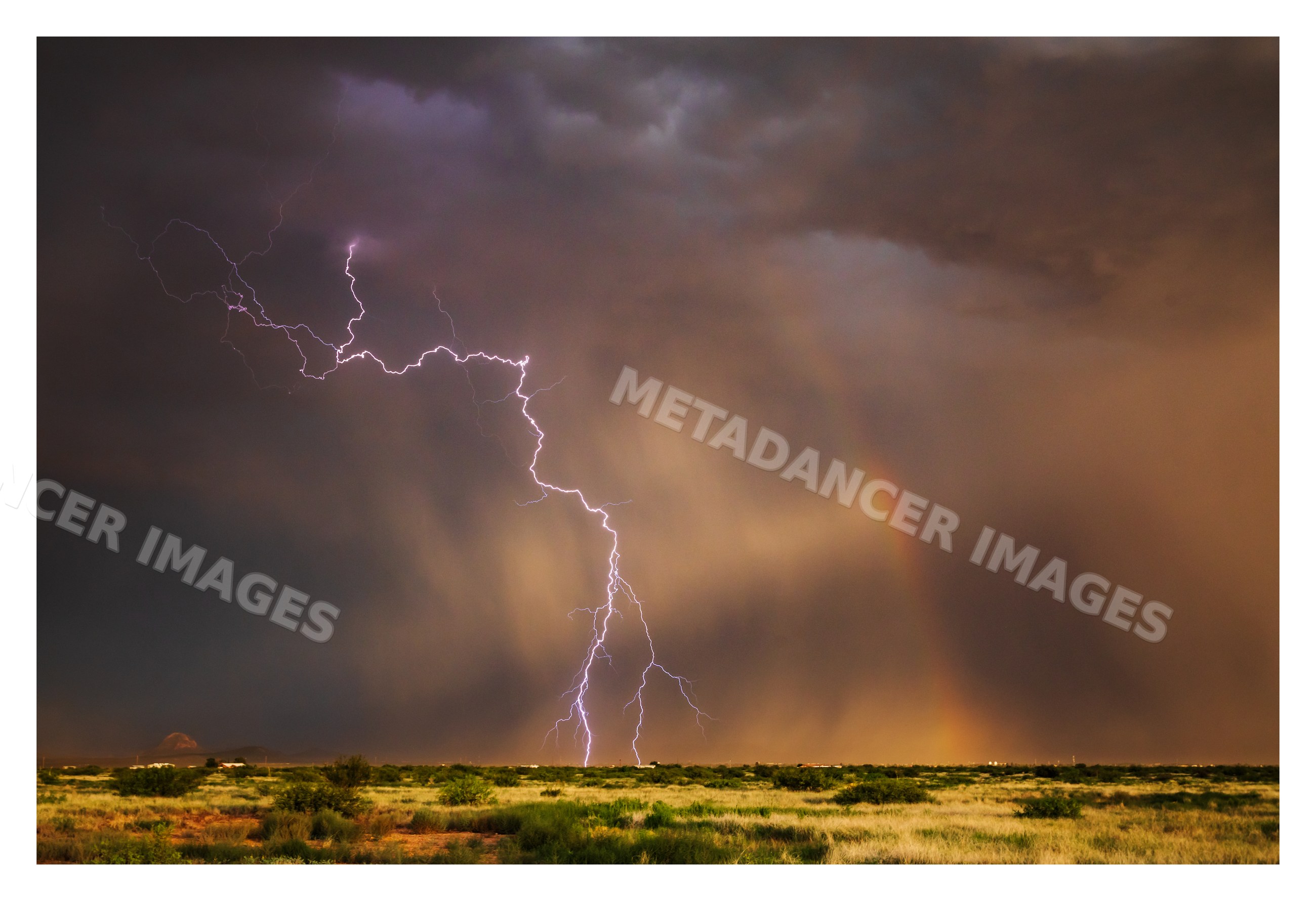 Lightning strike and Rainbow over desert landscape in douglas Arizona