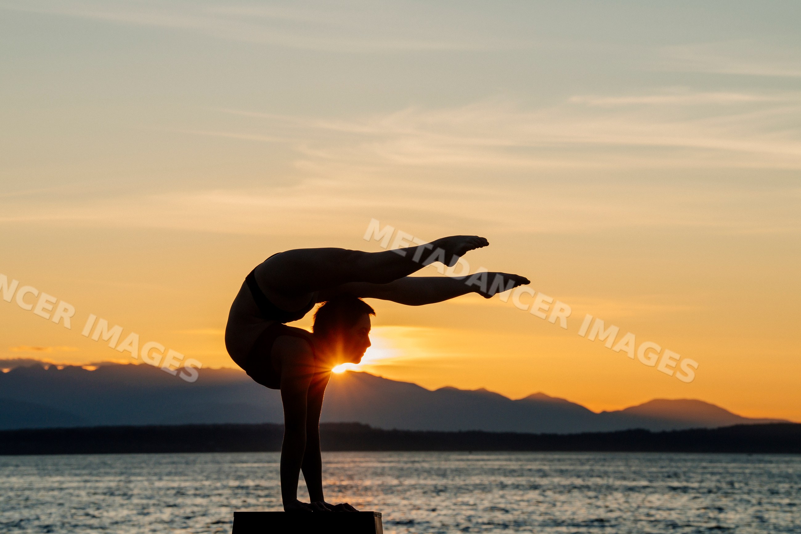White woman doing acrobatic handstand pose