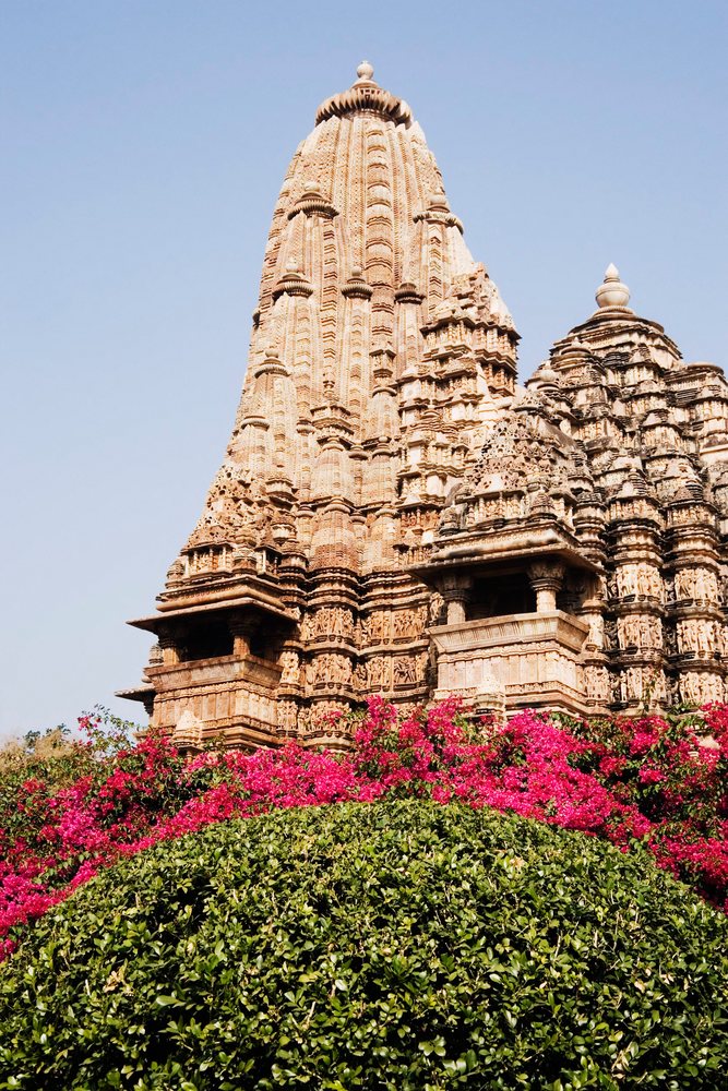 Khajuraho temple tower with intricate stone carvings, india