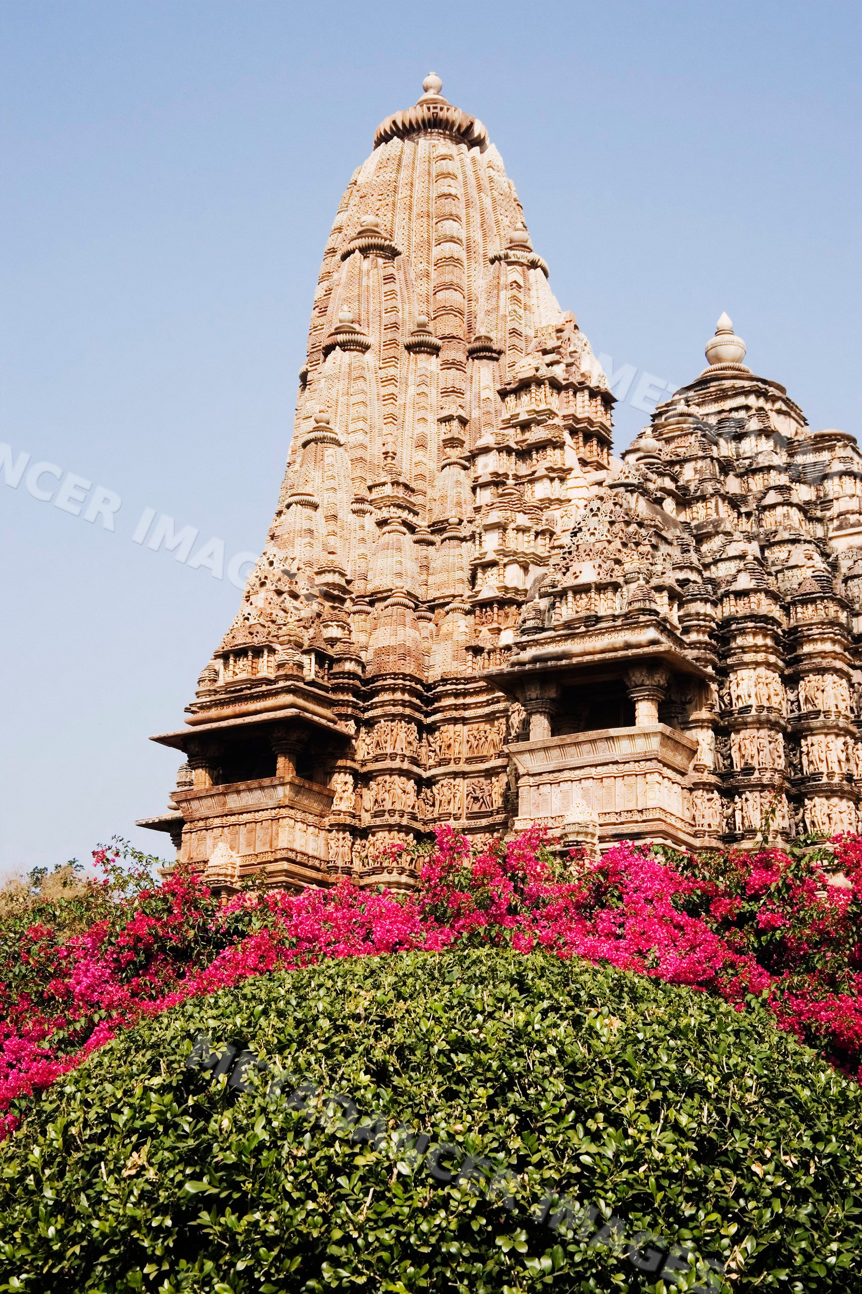 Khajuraho temple tower with intricate stone carvings, india