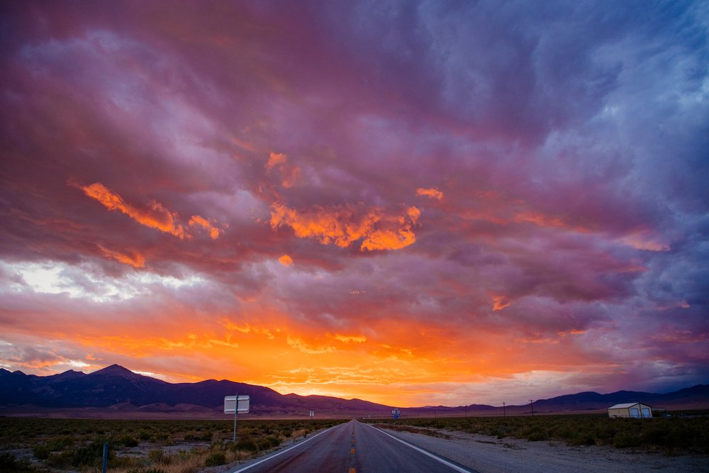 Sunset sky over open road and mountains in Nevada desert