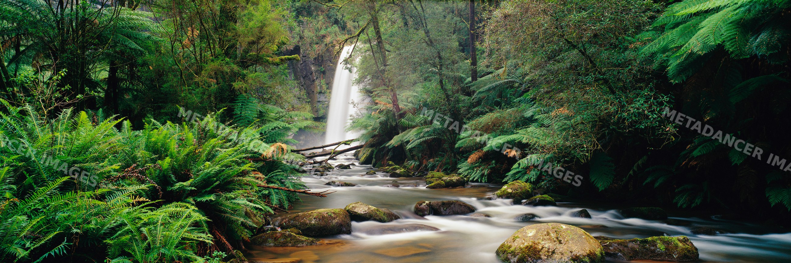 Waterfall flowing into river