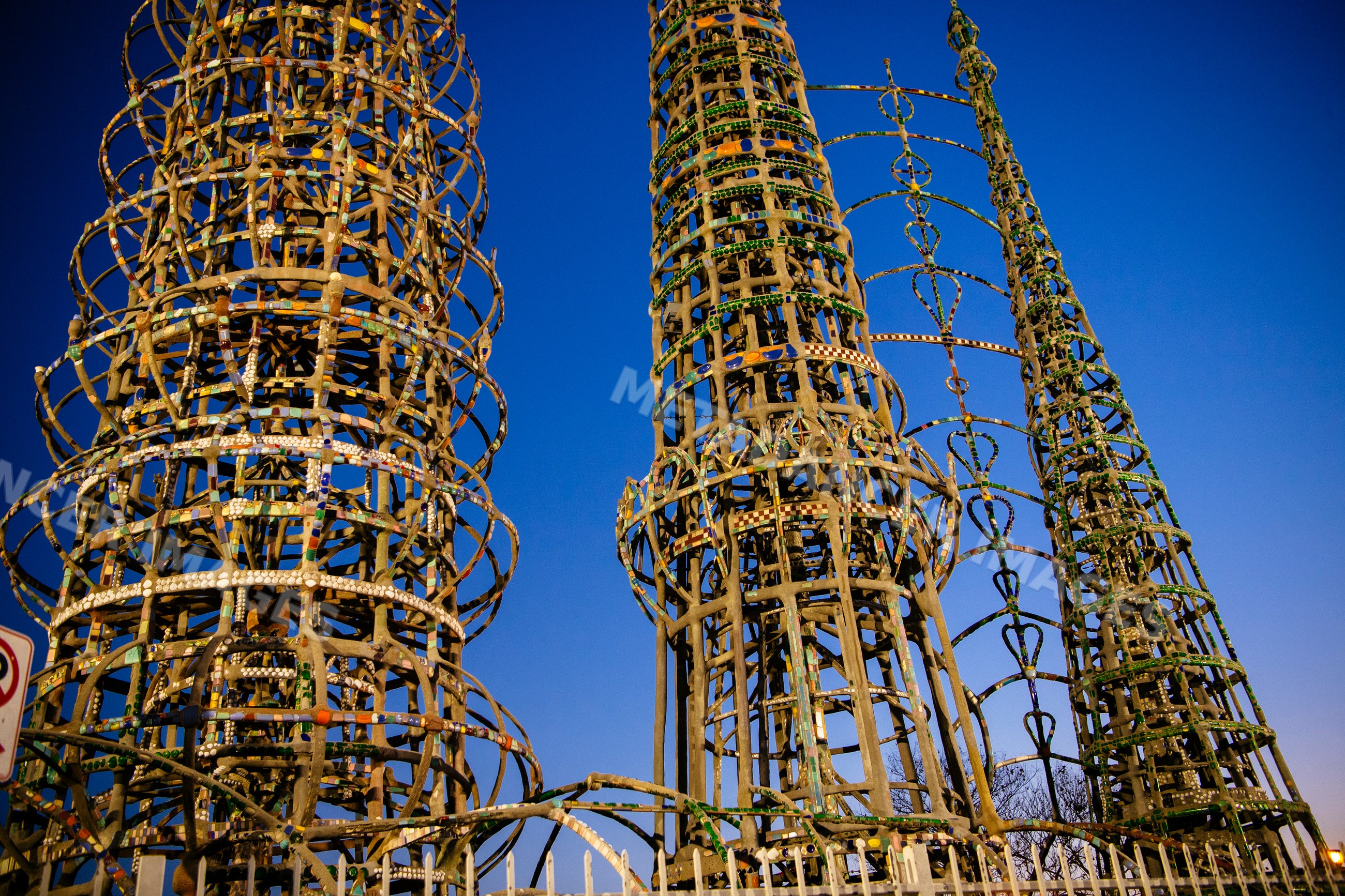 Watts towers metal sculpture installation against blue sky