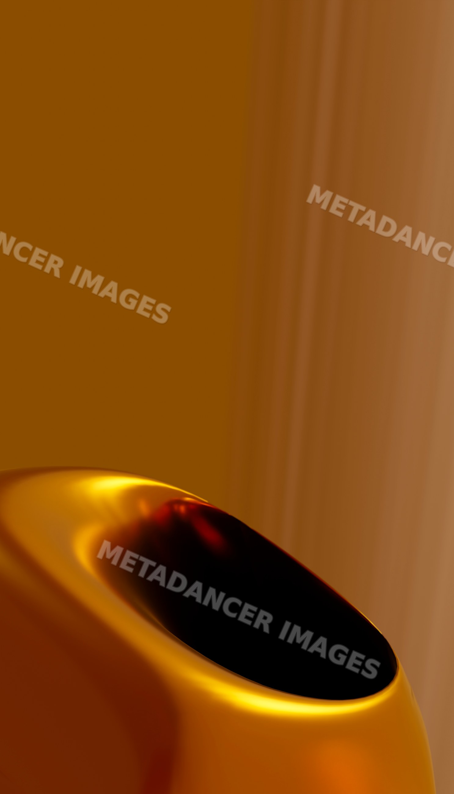 Golden abstract curved metallic object with shiny surface macro