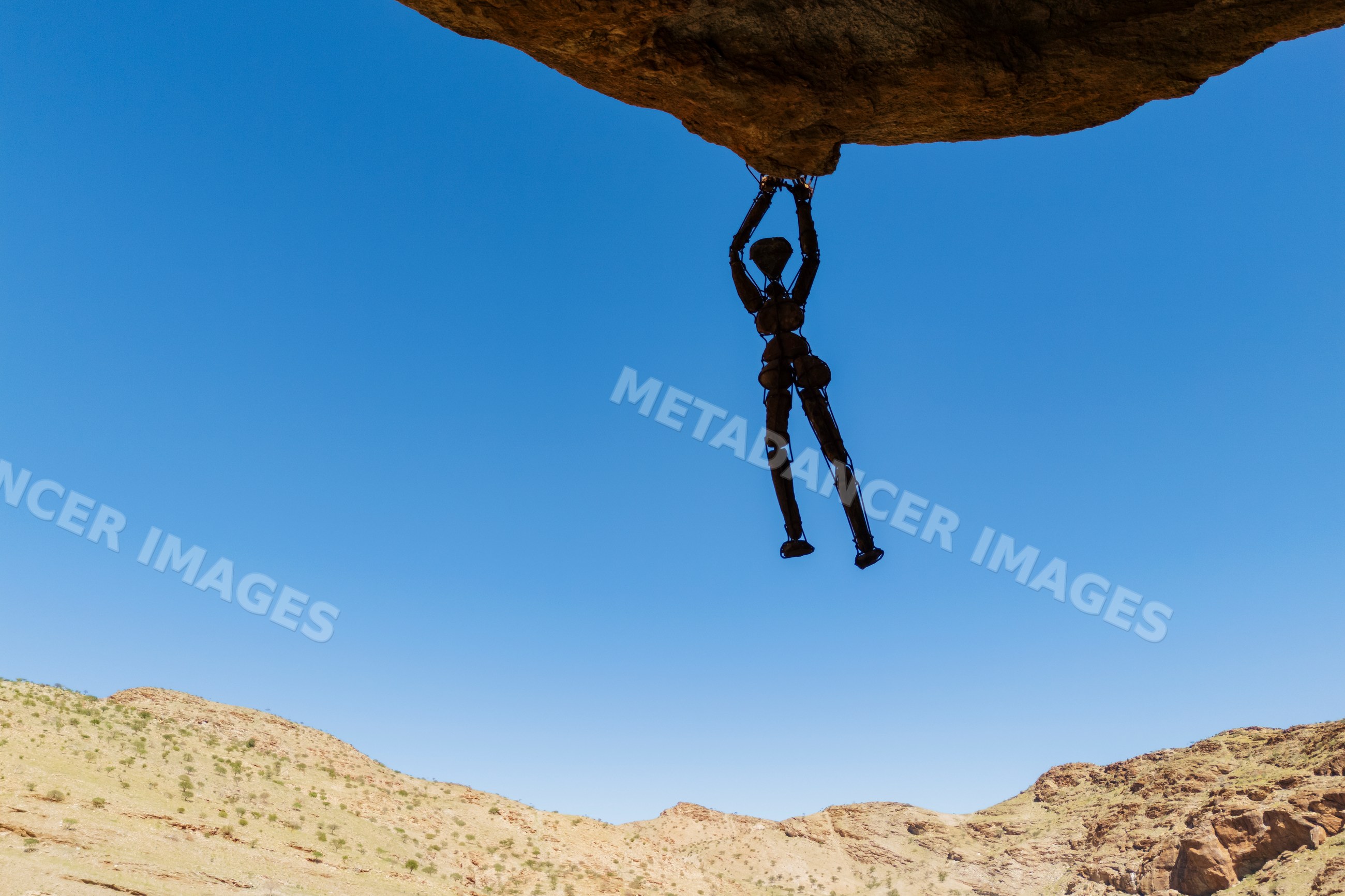 Rock Man wire sculpture on a boulder Namibia
