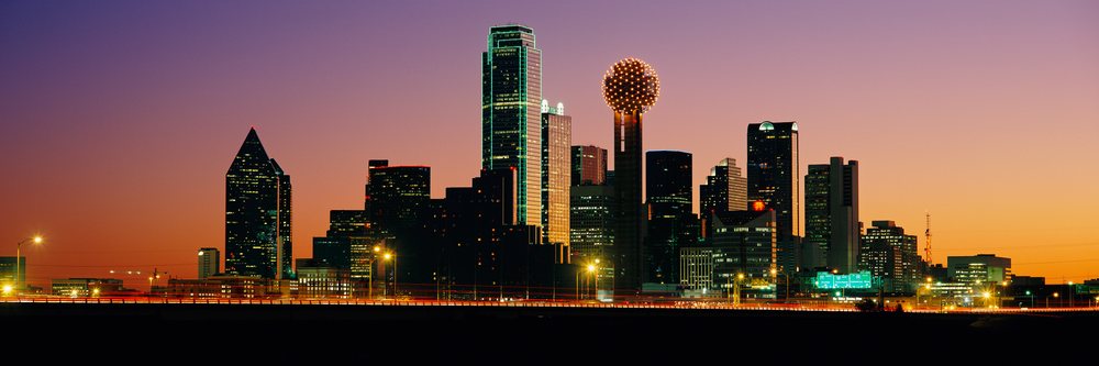 Dallas city skyline at sunset with illuminated skyscrapers