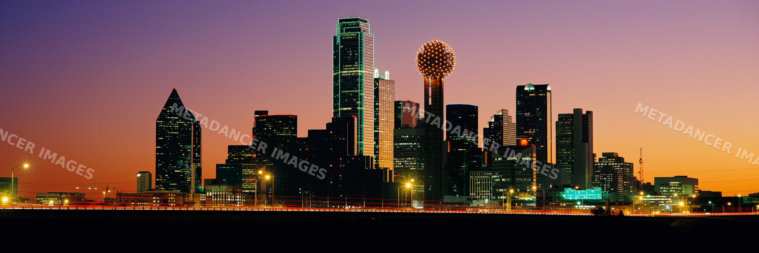 Dallas city skyline at sunset with illuminated skyscrapers