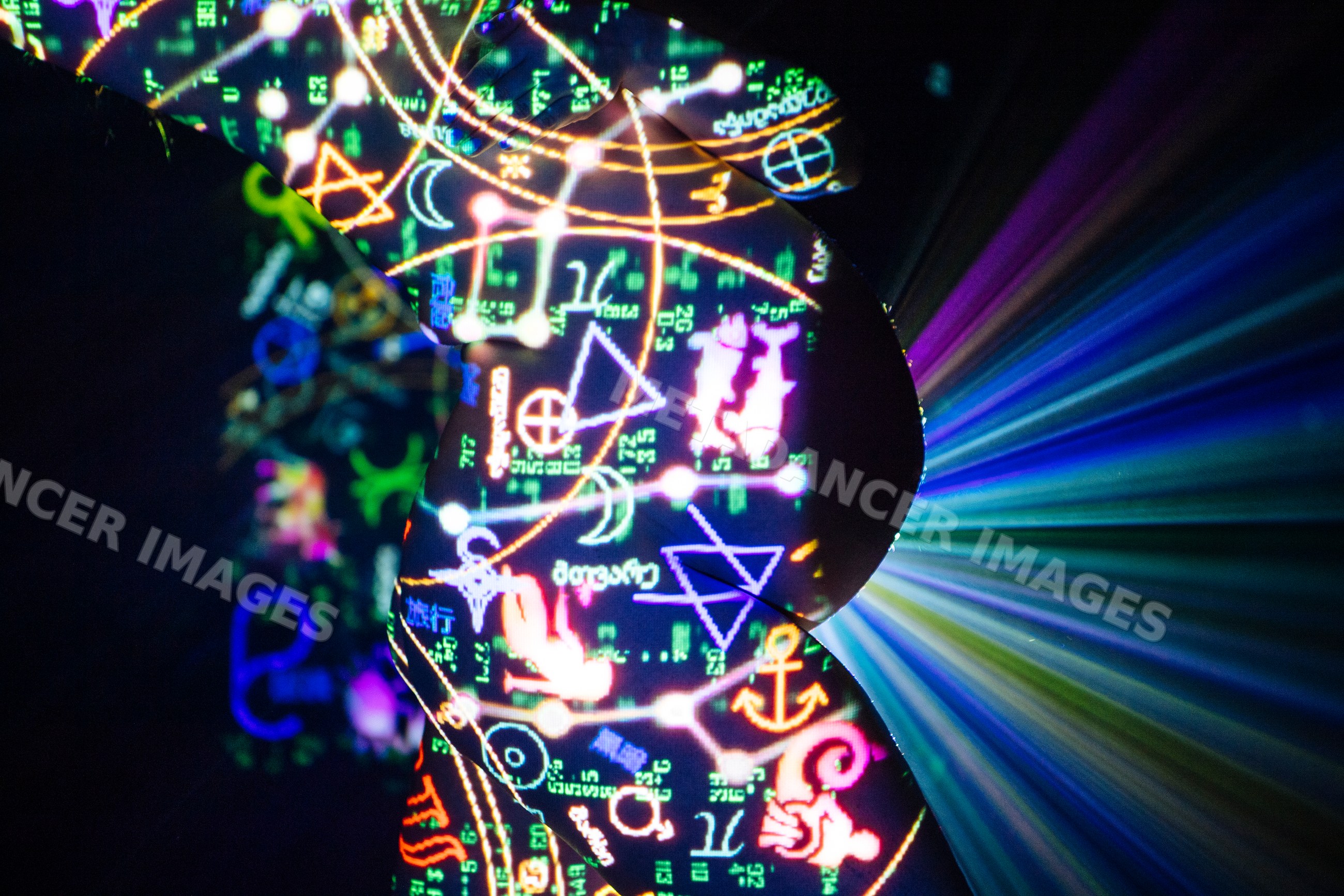 Pregnant white woman silhouette with colorful symbols projected