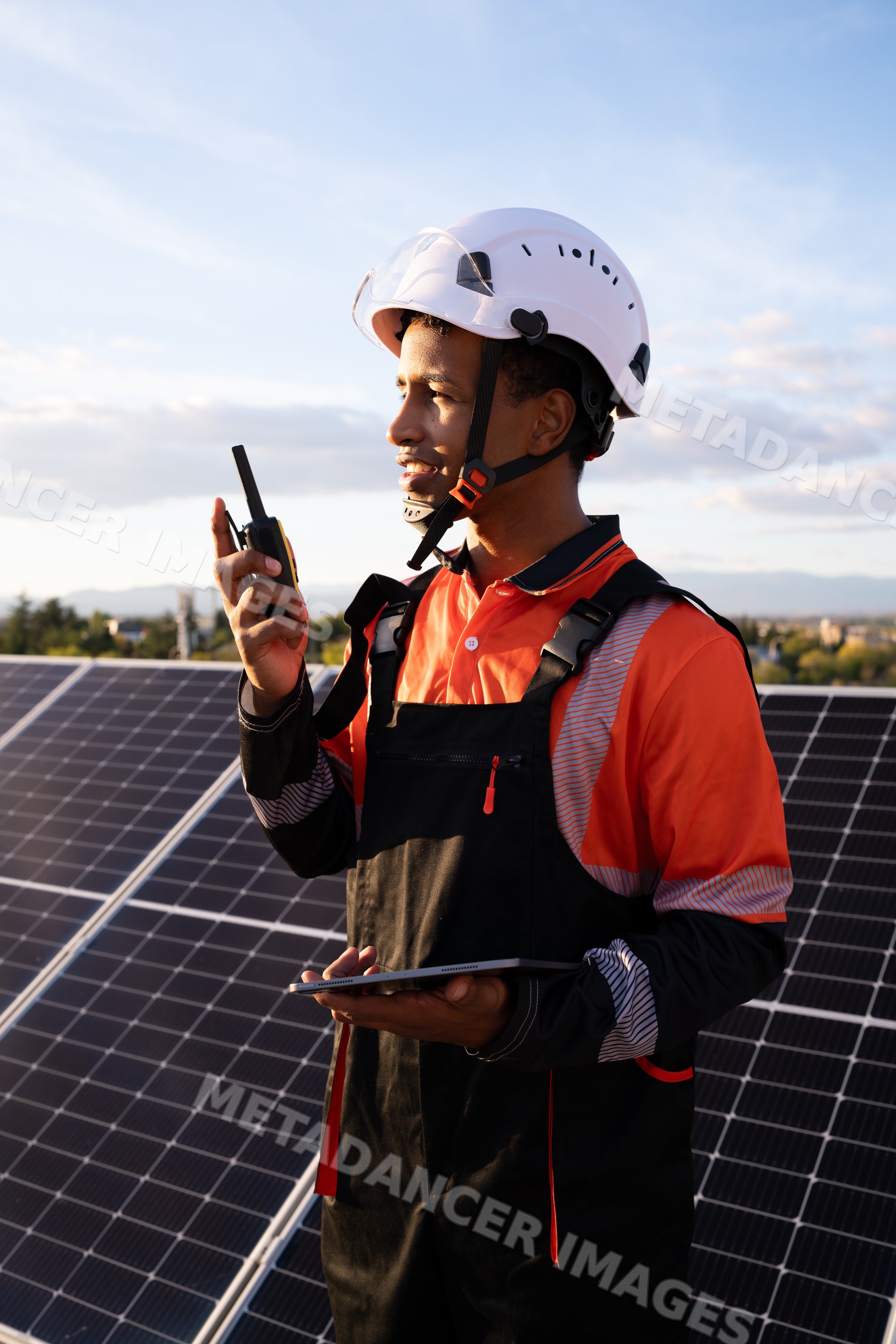 Worker communicating next to solar panels in Madrid solar energy field