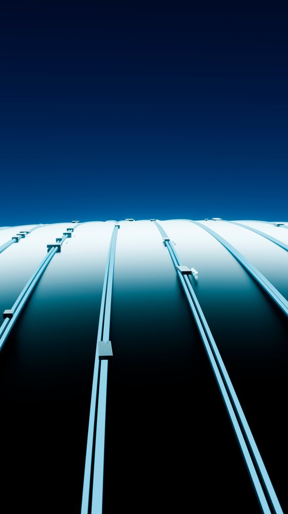 Curved metal dome with blue structural ribs under clear sky
