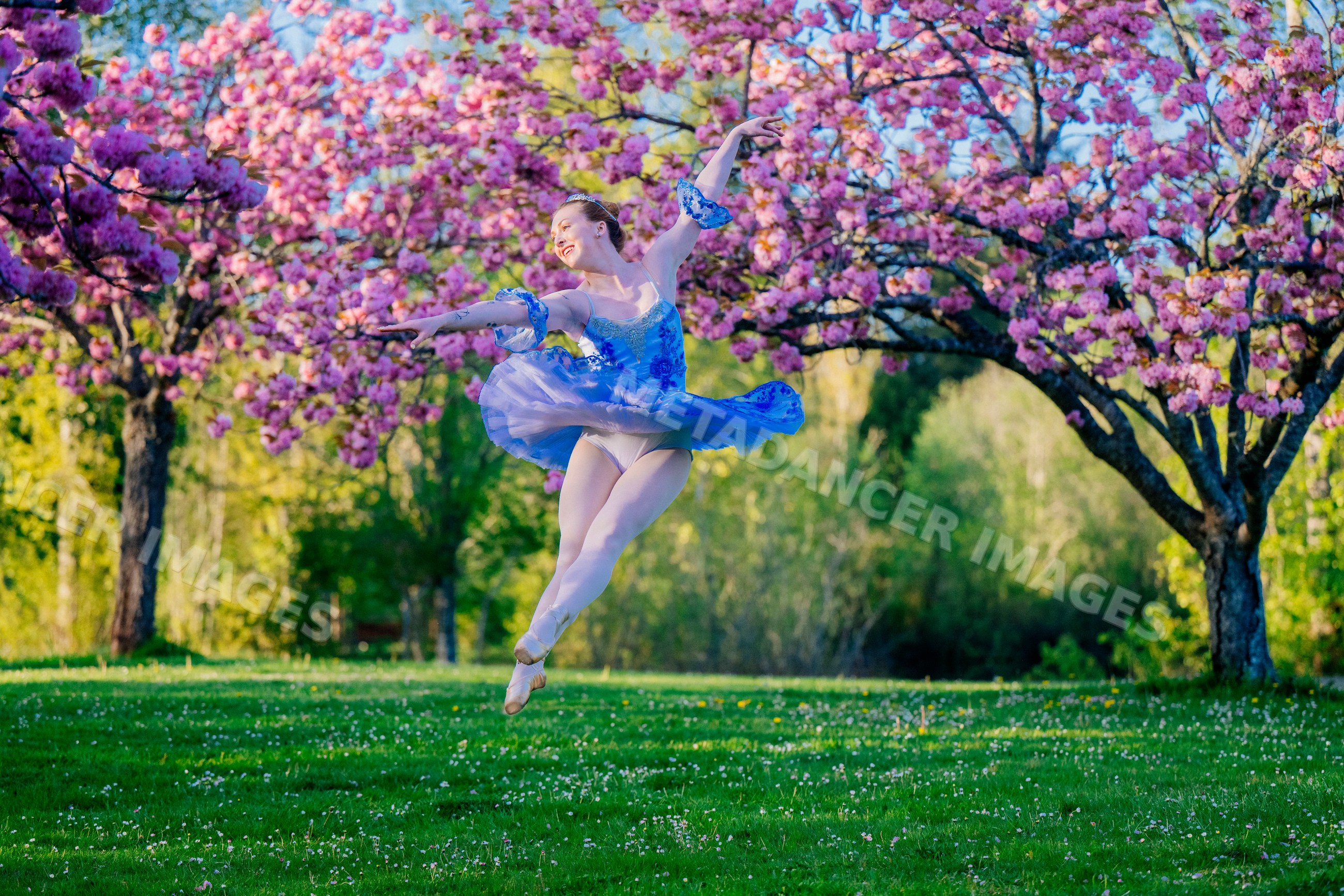 Ballerina jumping gracefully outdoors