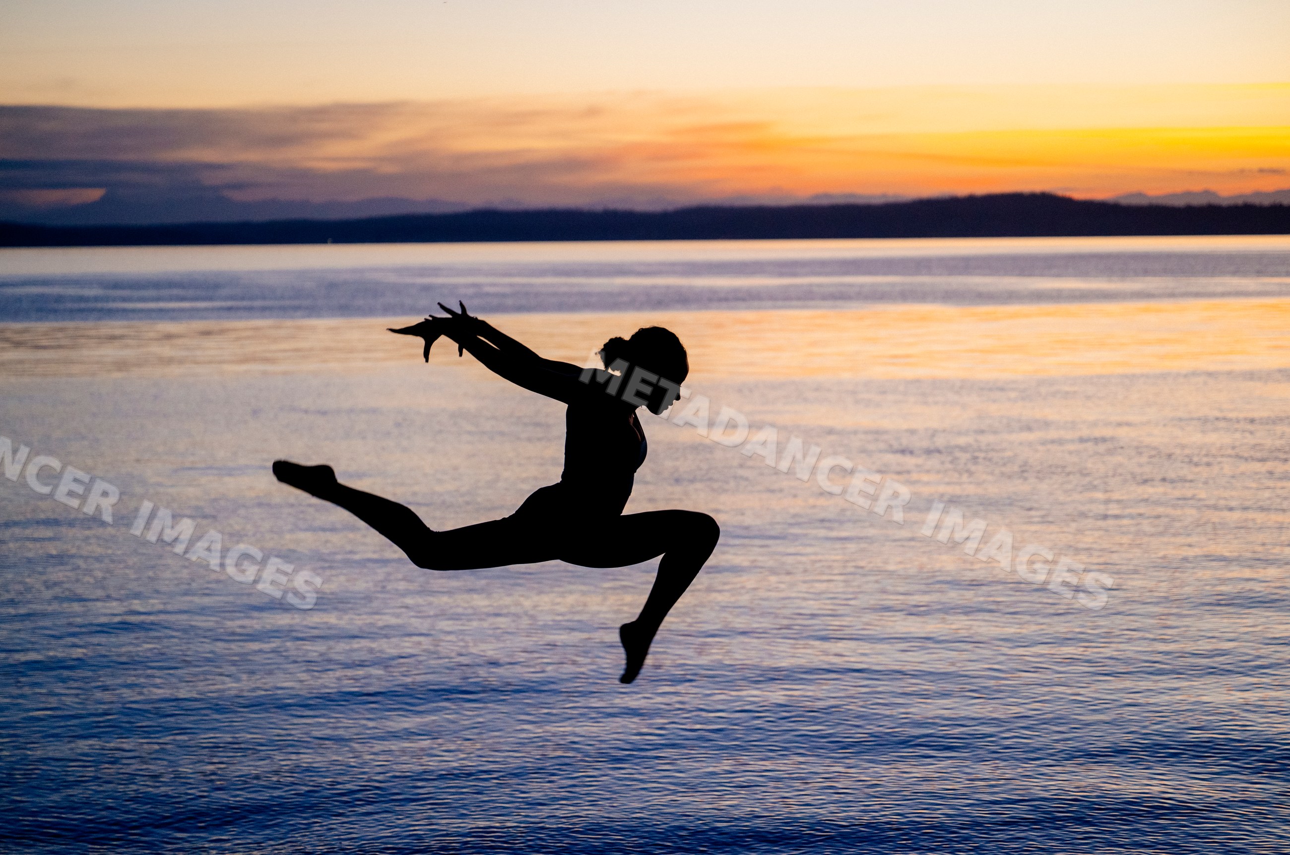 Hispanic woman performing yoga acrobatic jump