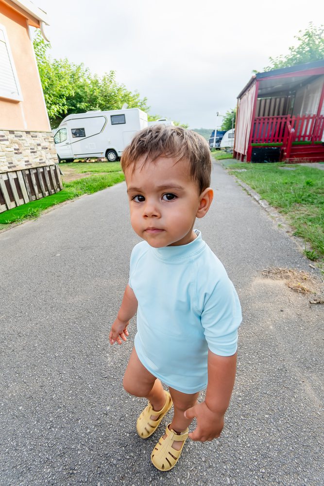 Toddler white boy walking outdoors