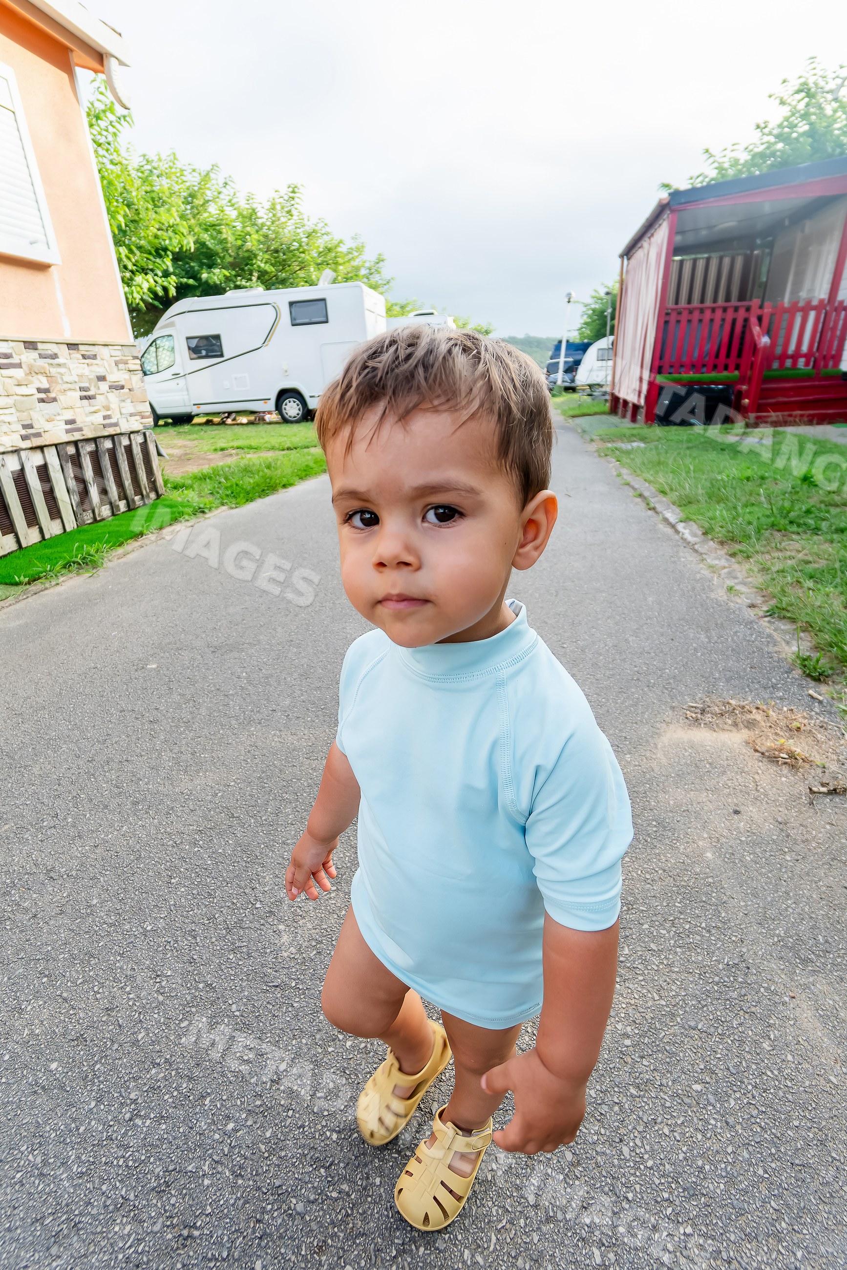 Toddler white boy walking outdoors