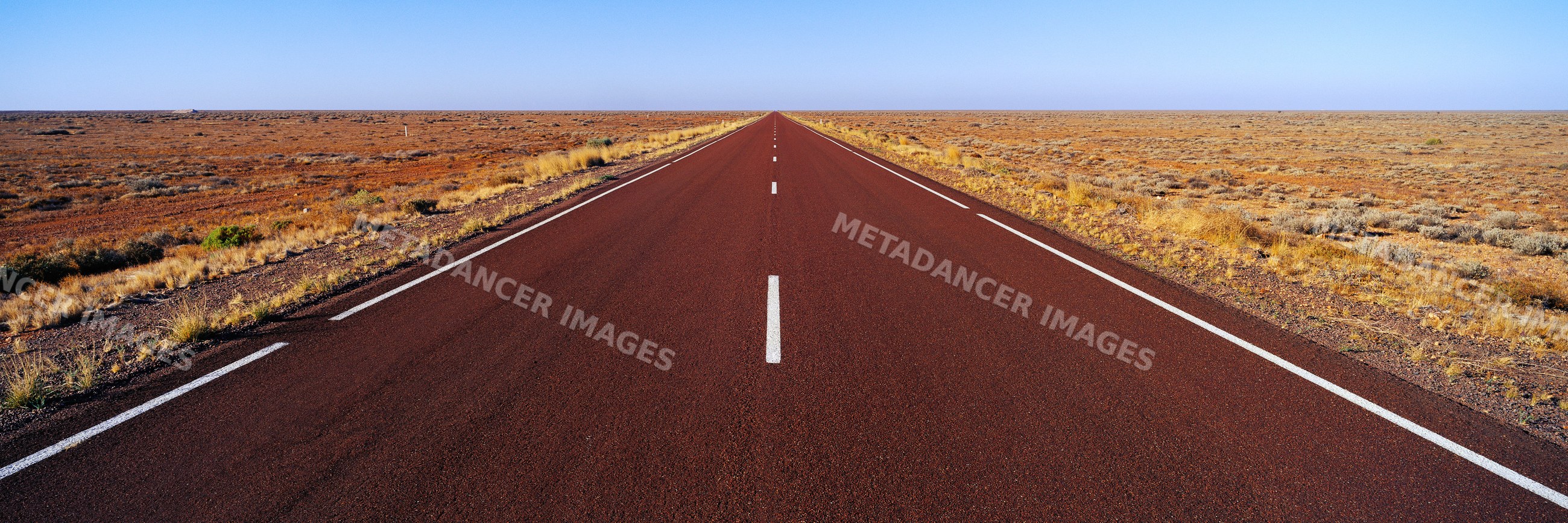 Stuart highway running through arid desert