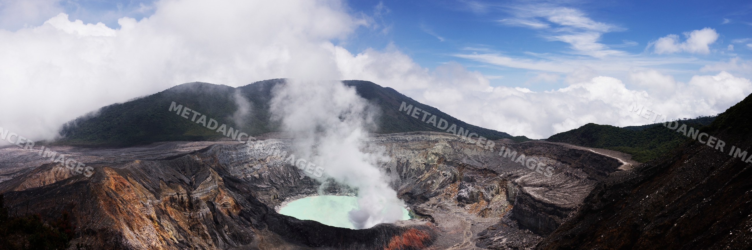 Poas volcano crater with steam and rugged volcanic landscape