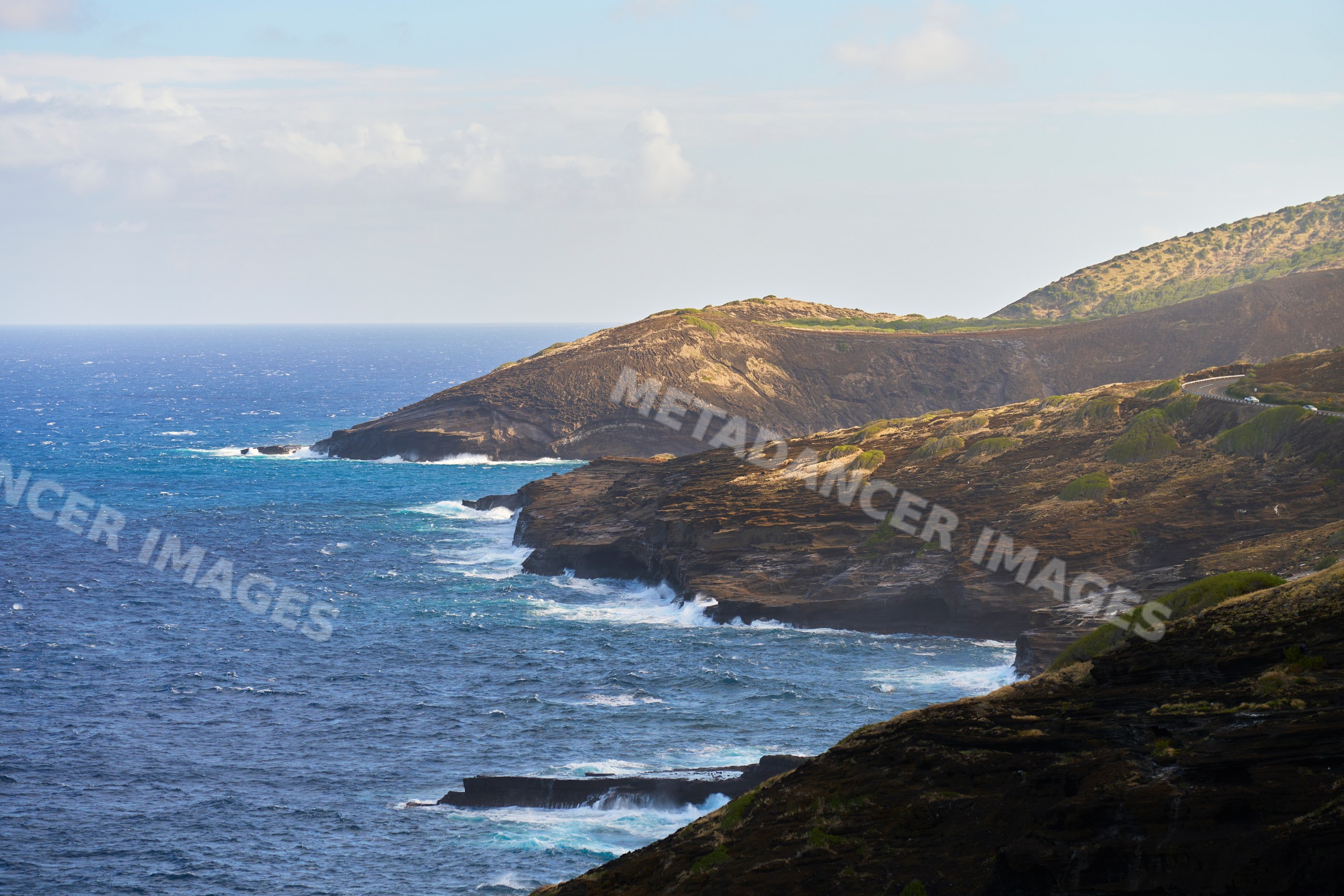 Rocky ocean coastline with winding coastal road Hawaii