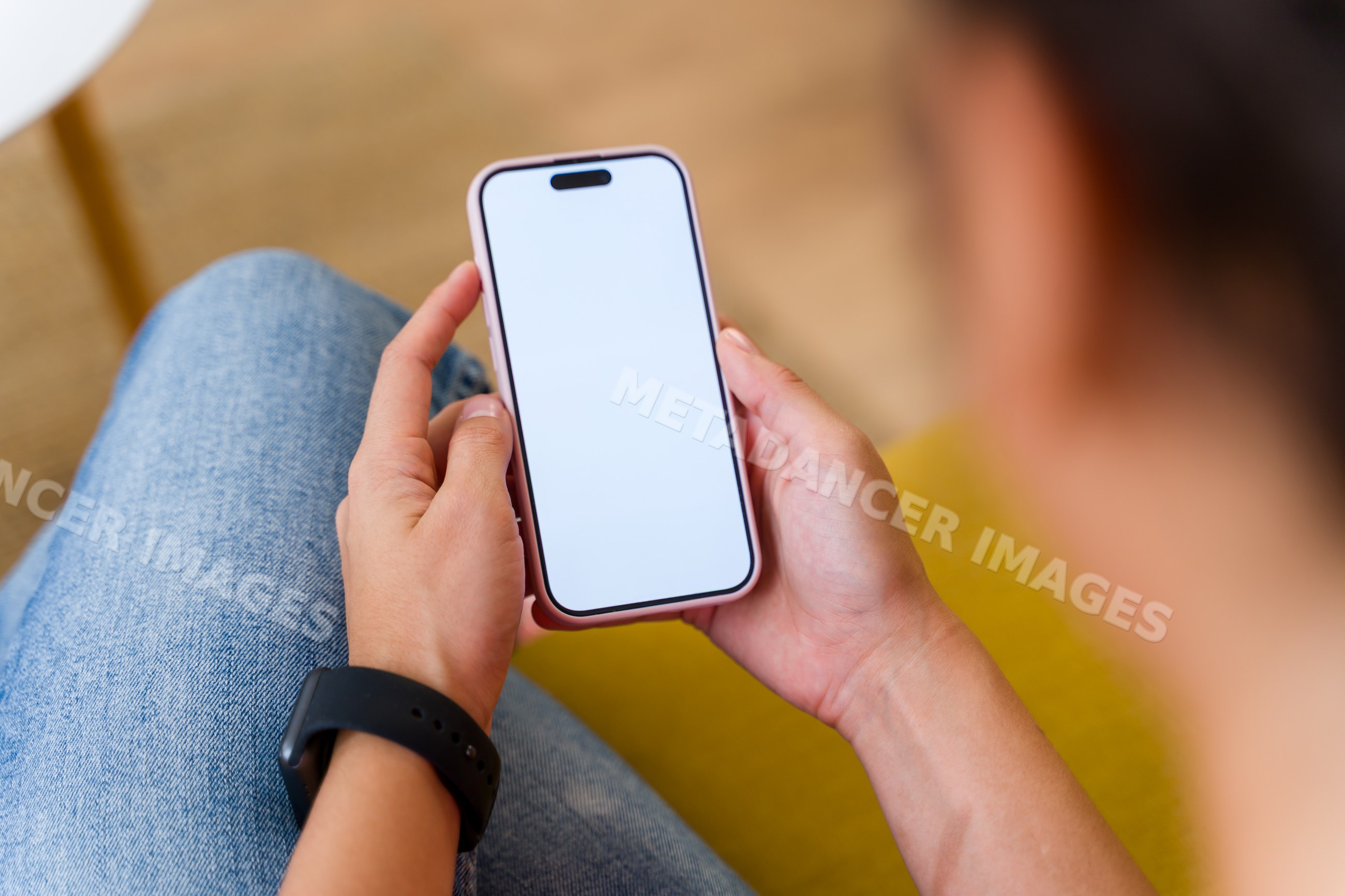 Hispanic Person holding mobile phone with blank screen