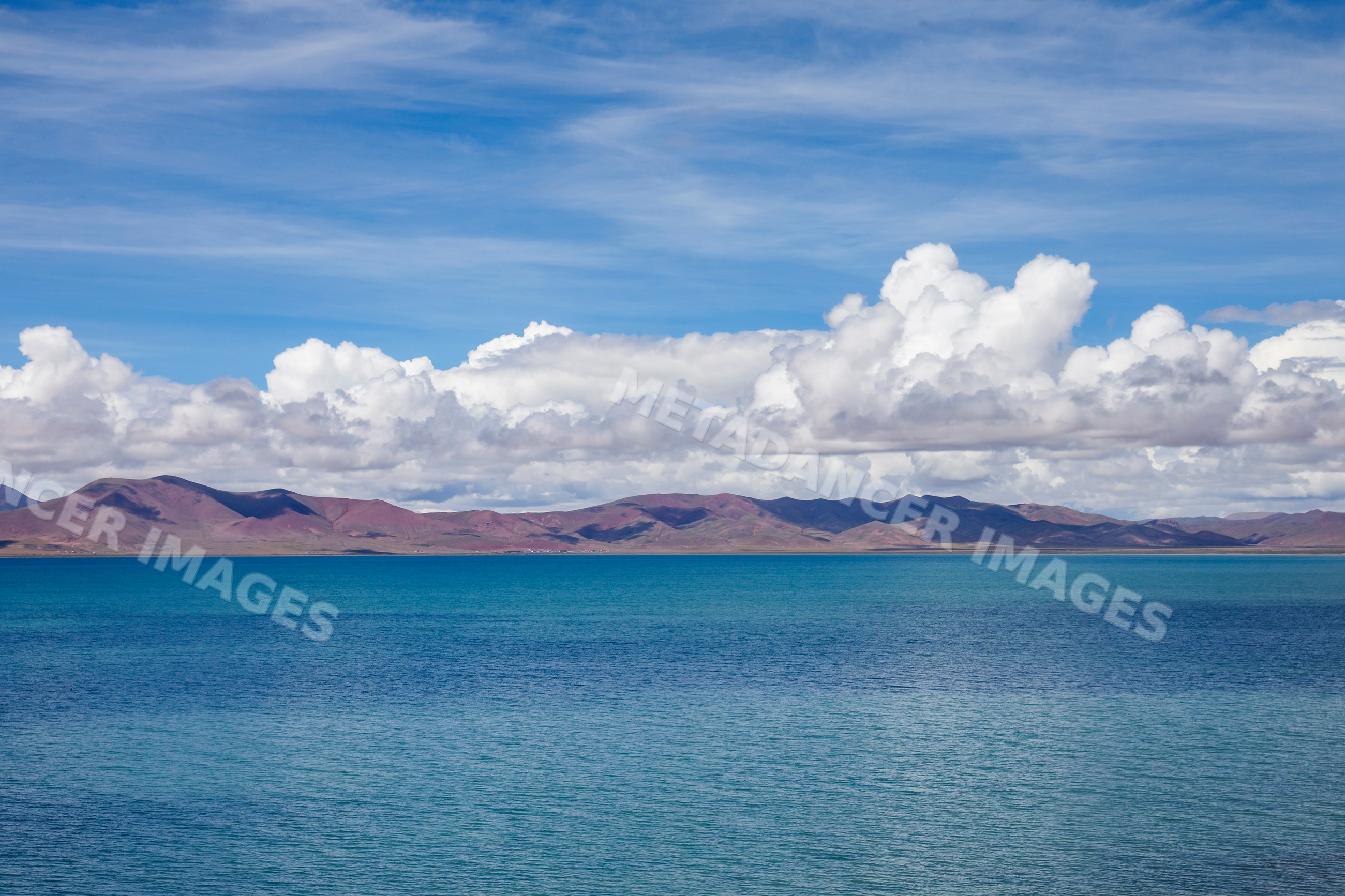 Lake Cuona with mountains and clouds