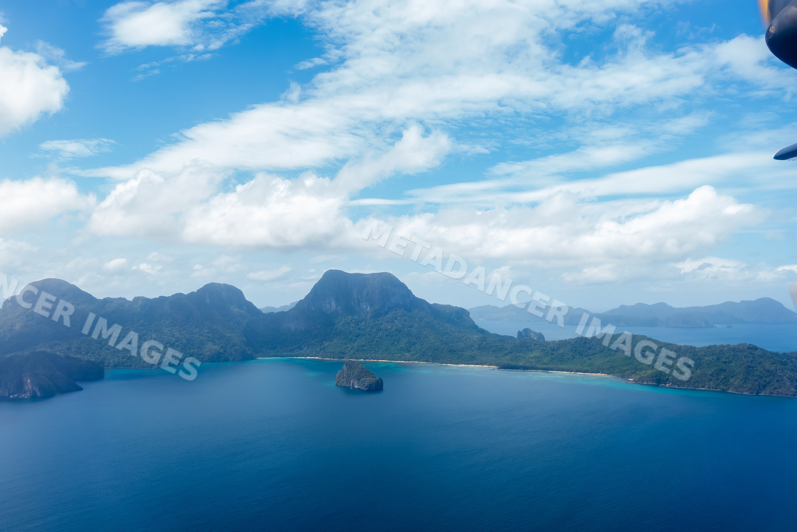 Island coastline and ocean view in the Philippines under blue sky