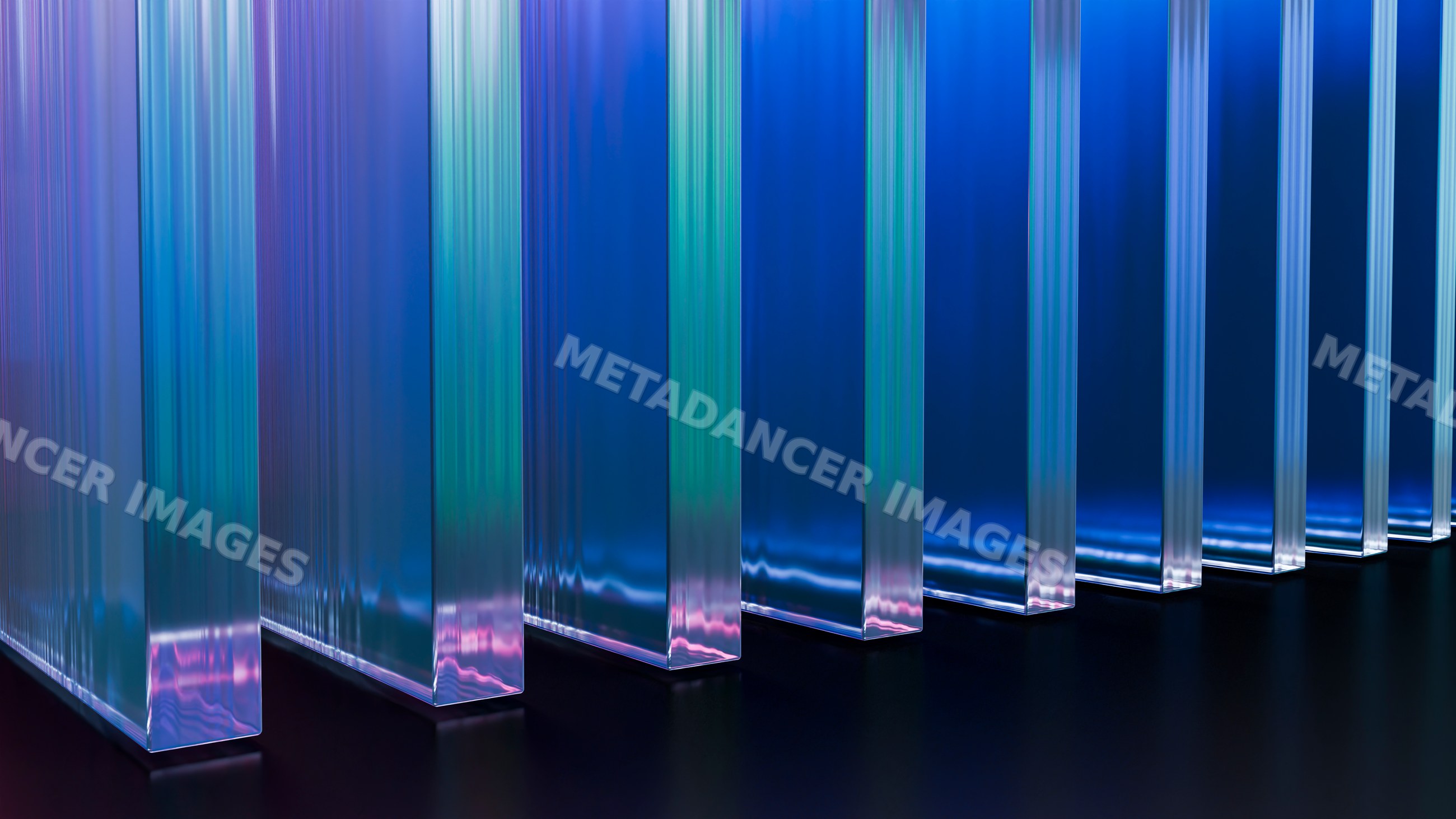 Vertical transparent glass panels with blue and purple reflections