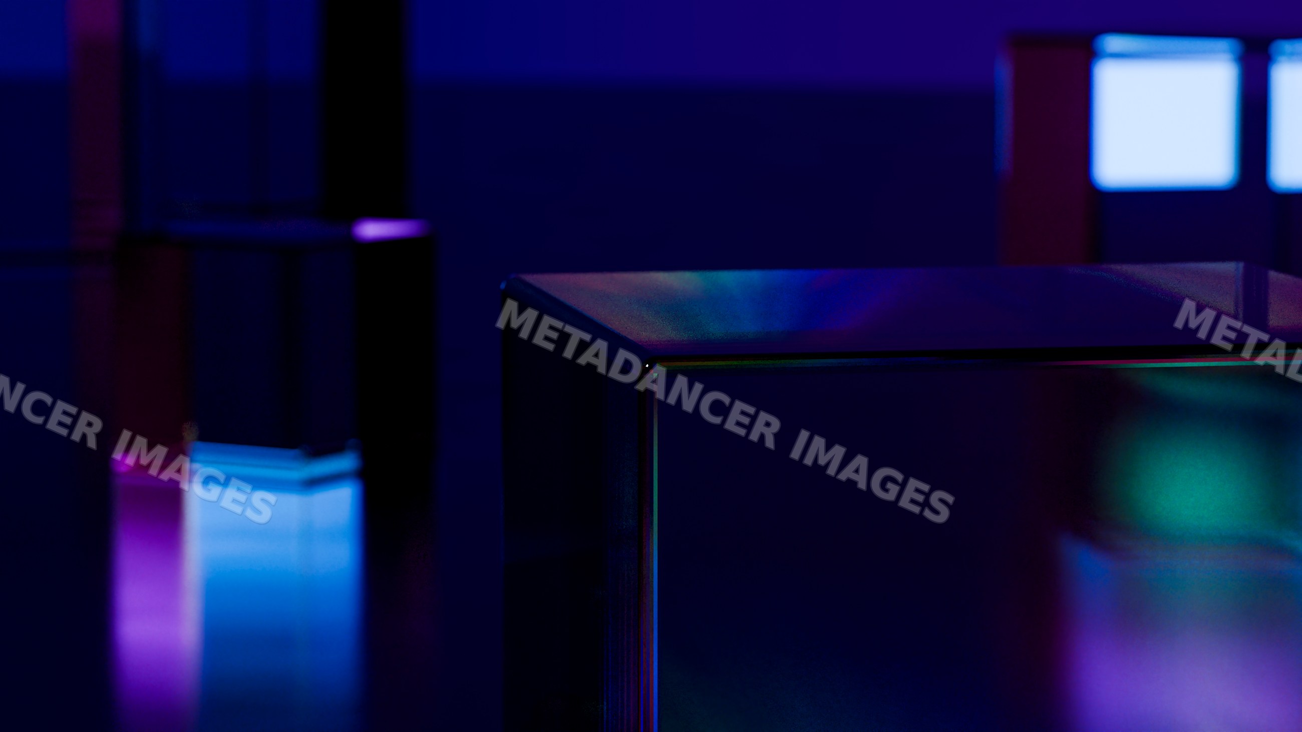 Glass cubes illuminated by neon blue and purple lights with reflective