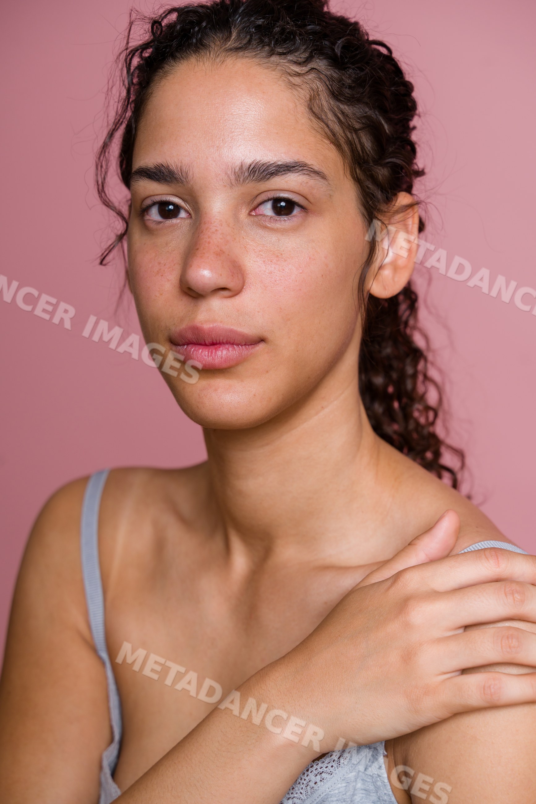 Close-up portrait of Hispanic woman with natural skin and curly hair