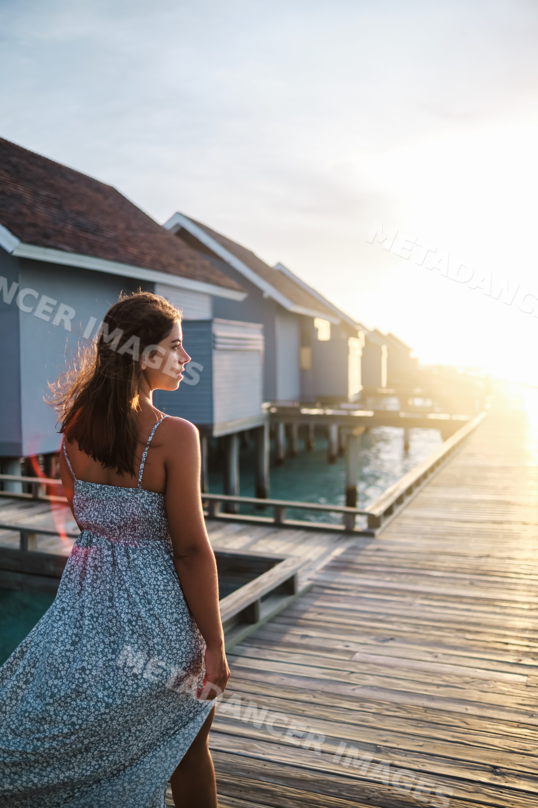 A white woman walks along a boardwalk