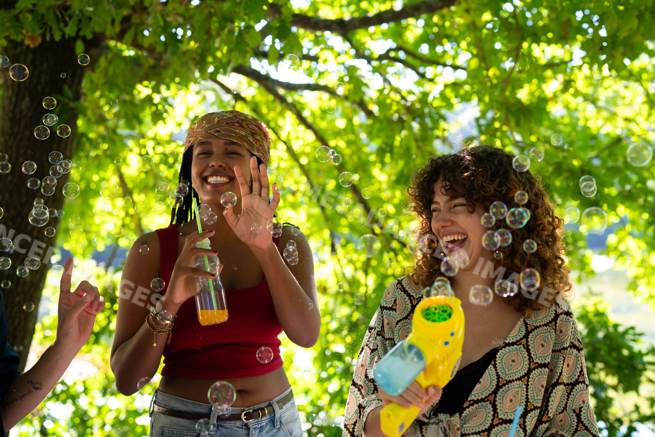 White and African American women enjoying bubbles and laughter