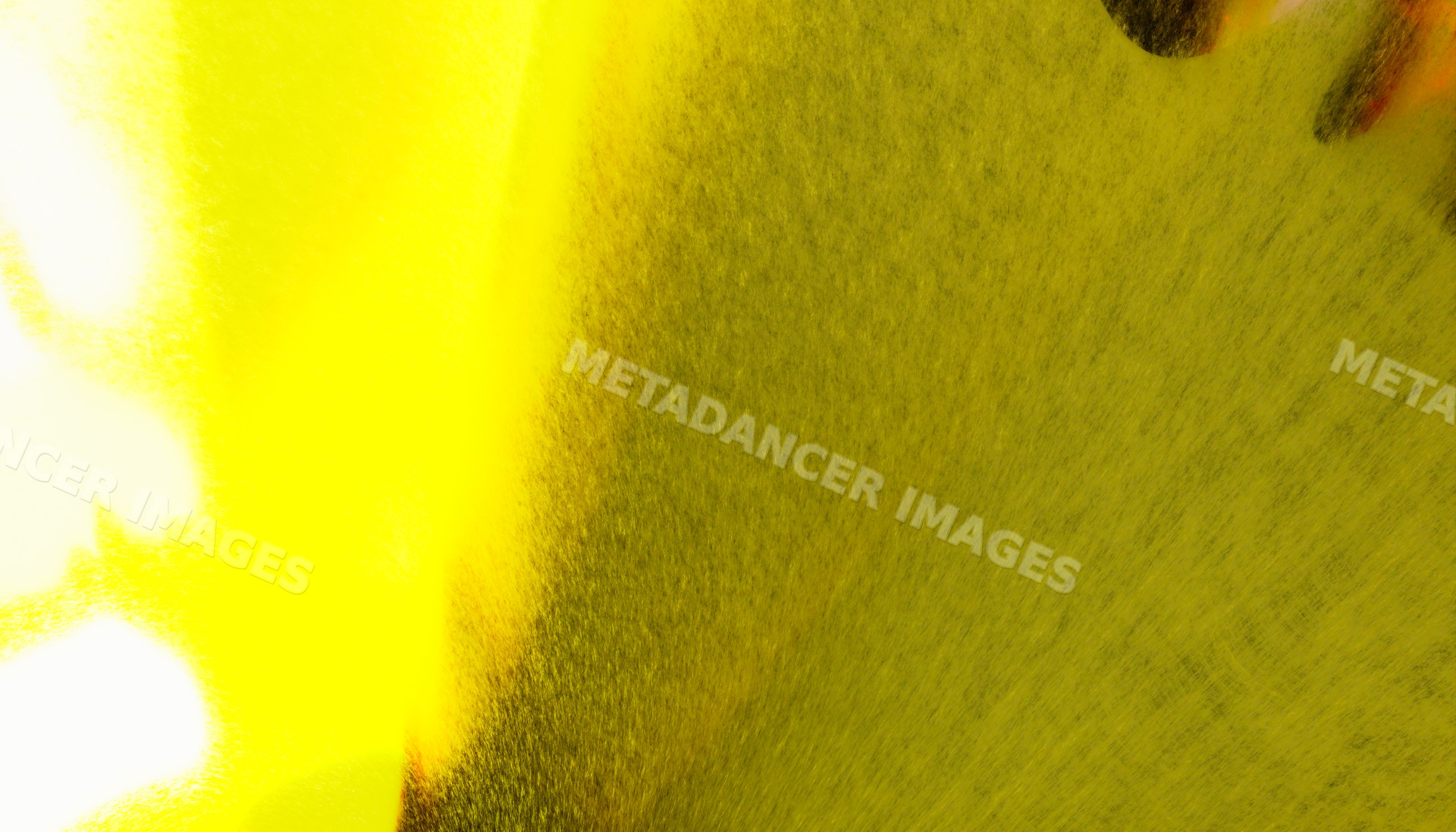 Close-up view of yellow spray paint particles creating a textured