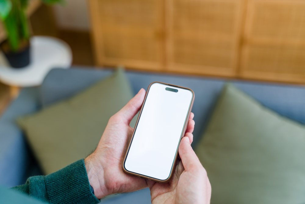 Smartphone held in hands with blank screen