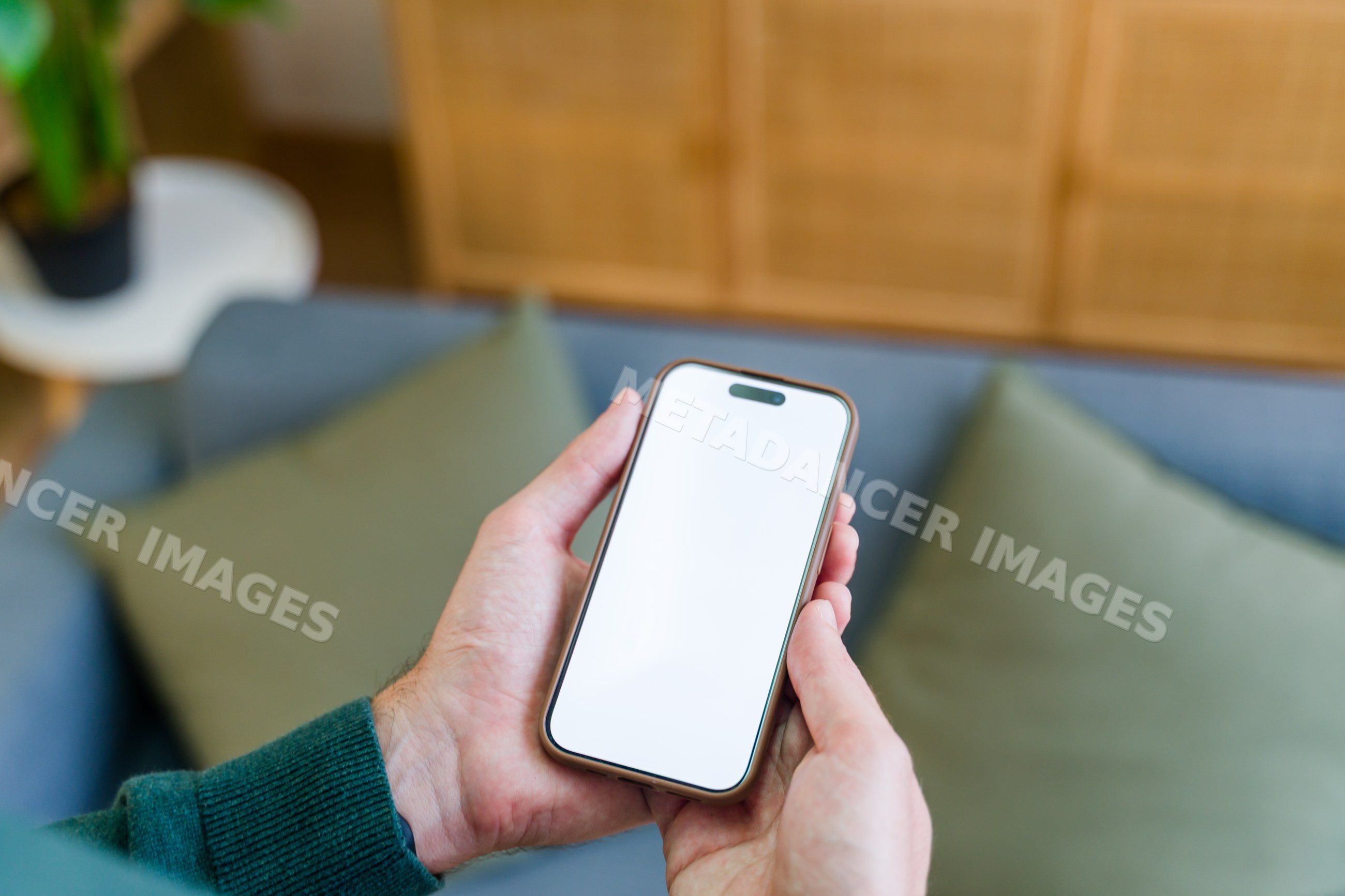 Smartphone held in hands with blank screen