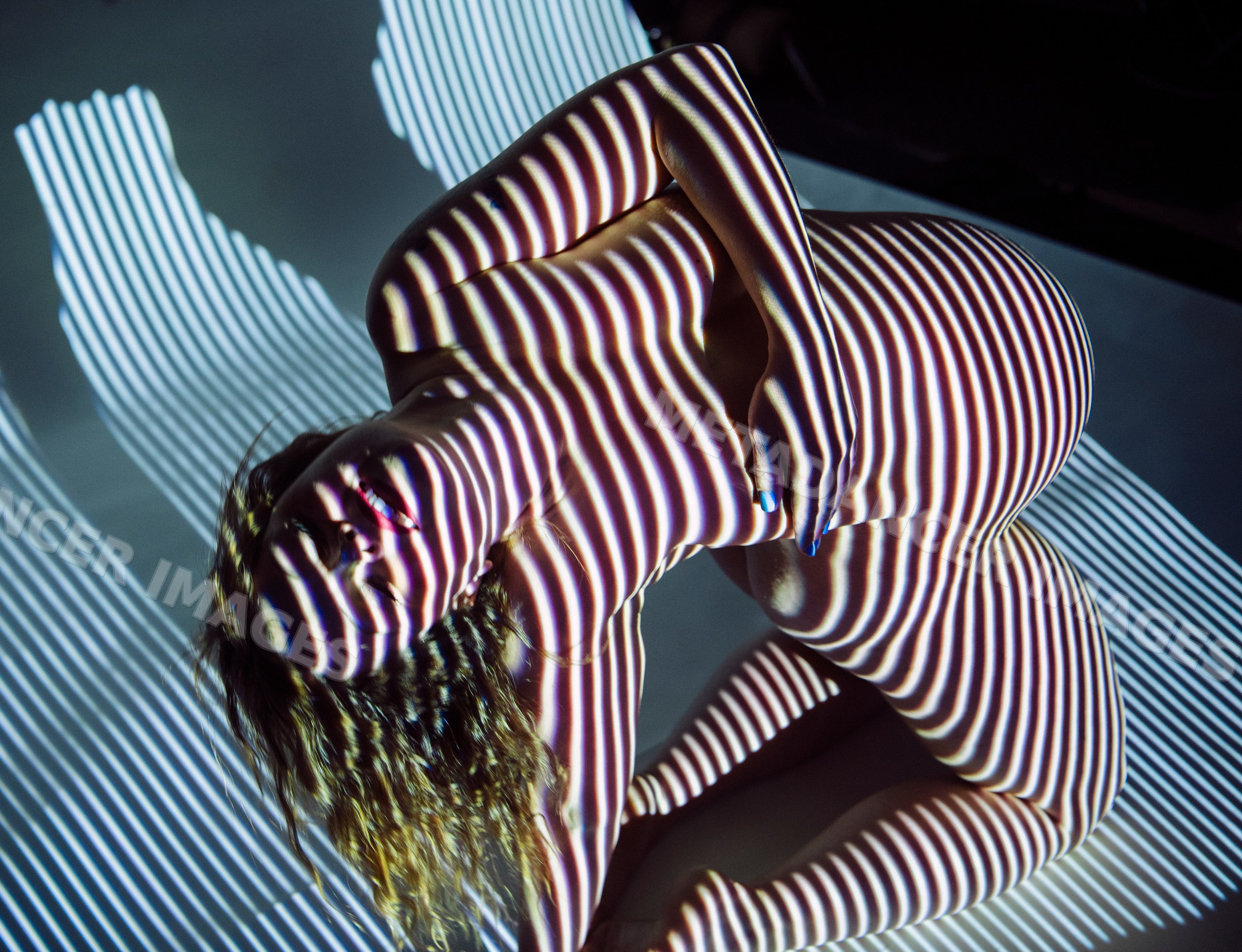 Pregnant white woman with striped light shadow pattern