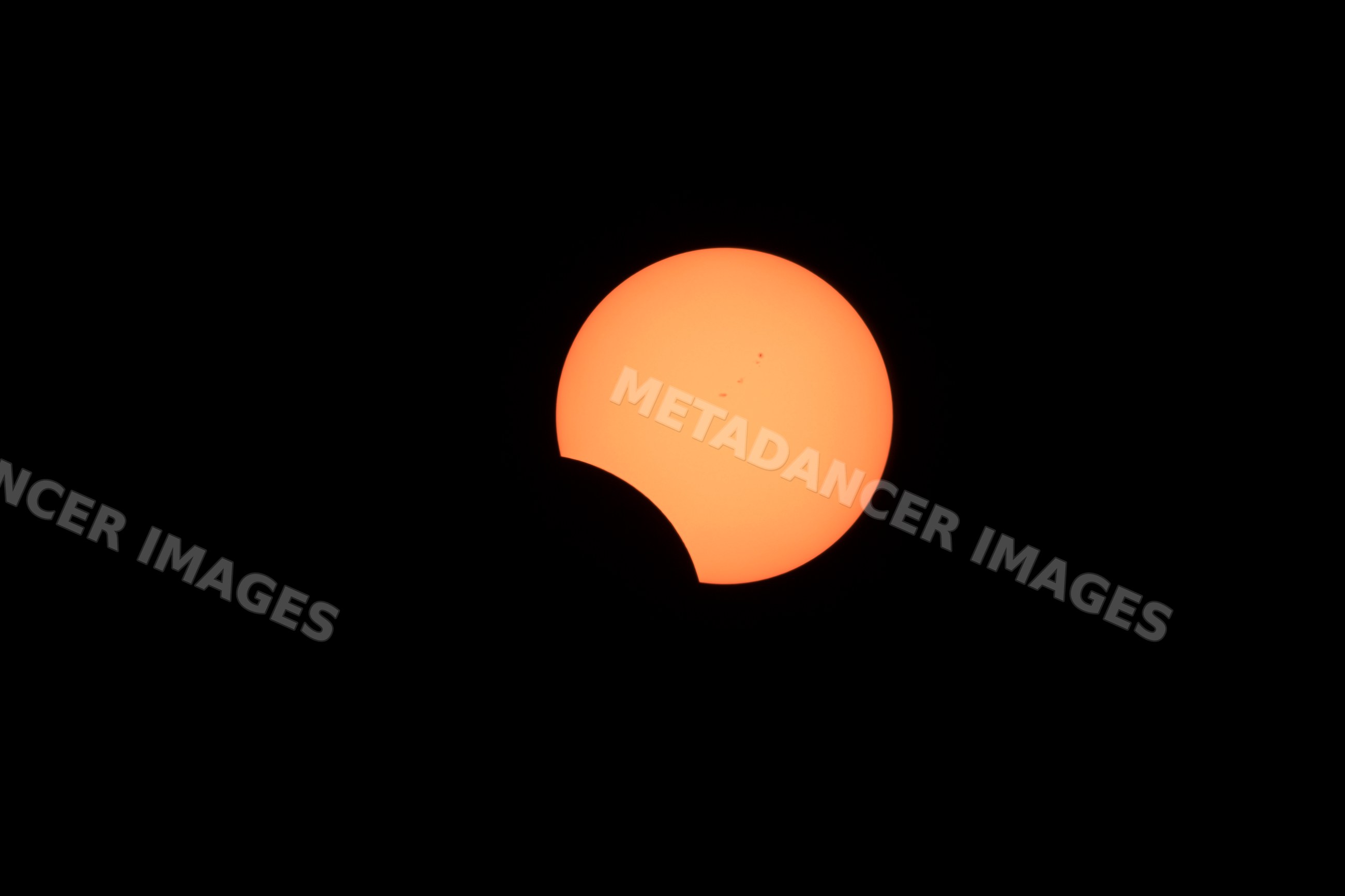 Solar eclipse with moon partially covering sun visible