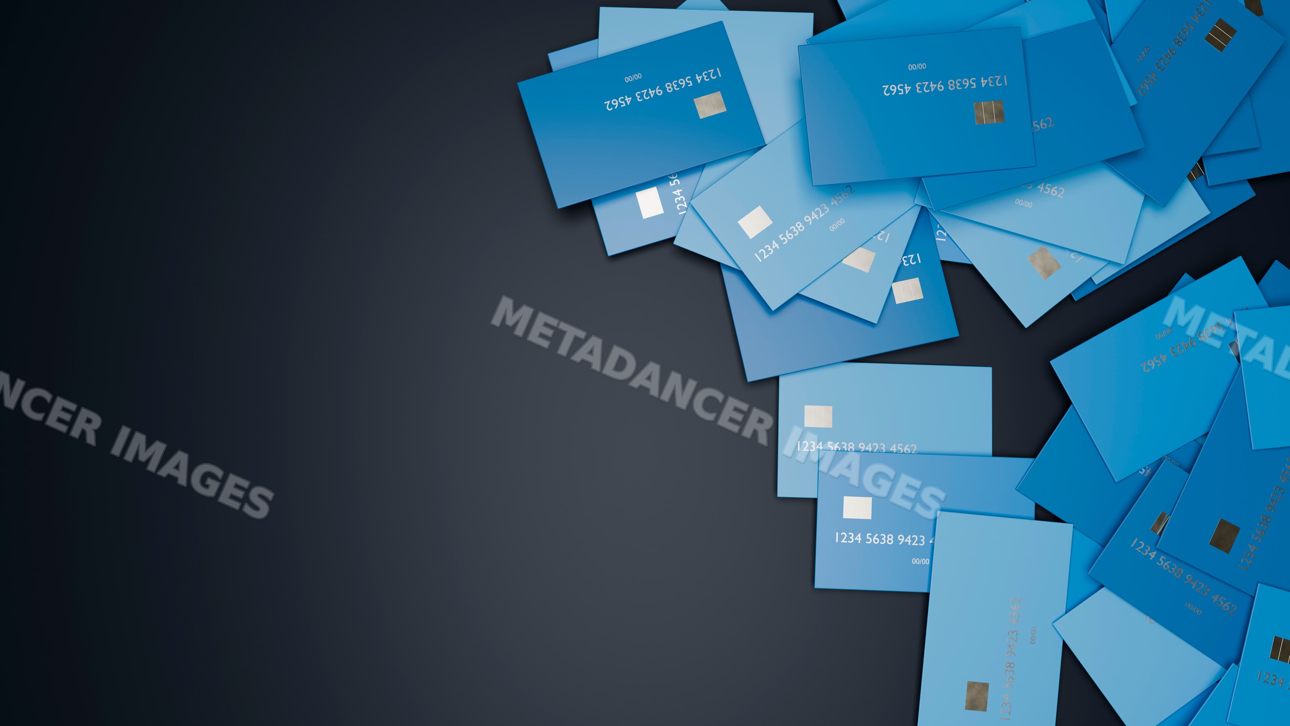 Pile of blue credit cards scattered on dark background
