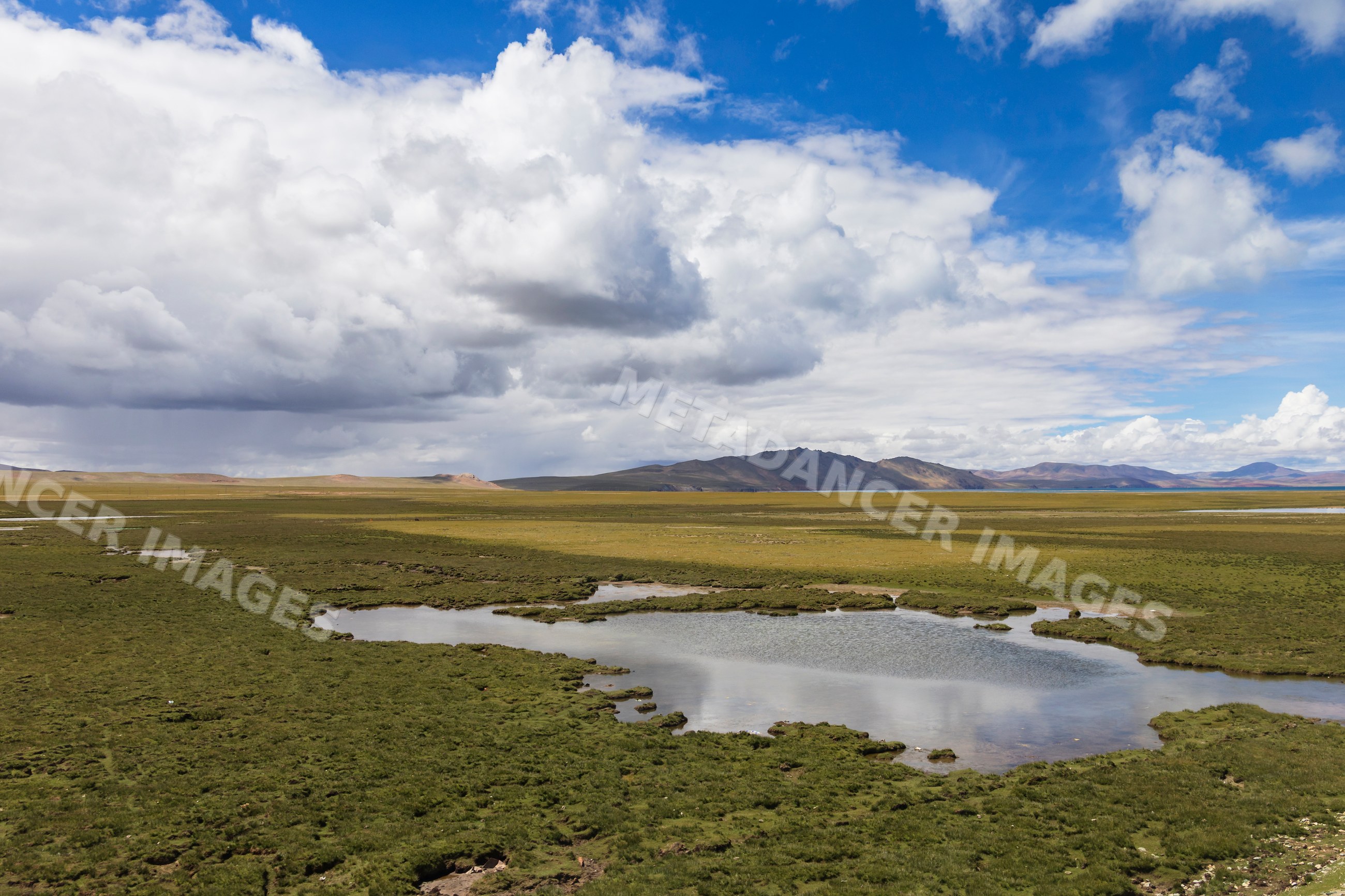 Tibetan plateau landscape with lake and mountains