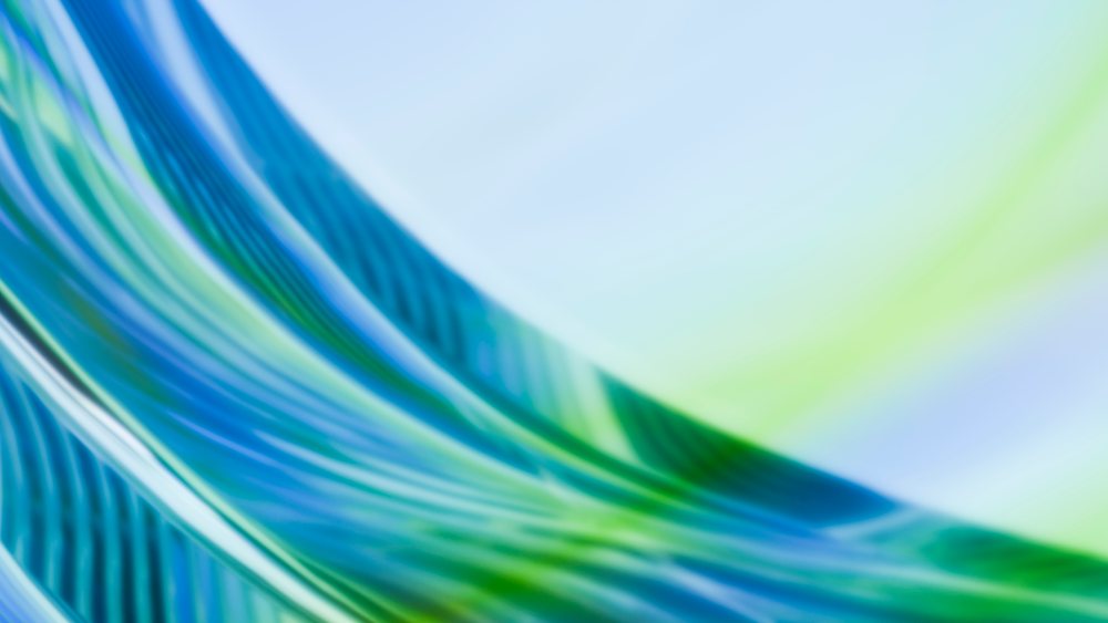Abstract digital illustration of flowing blue and green curved waves