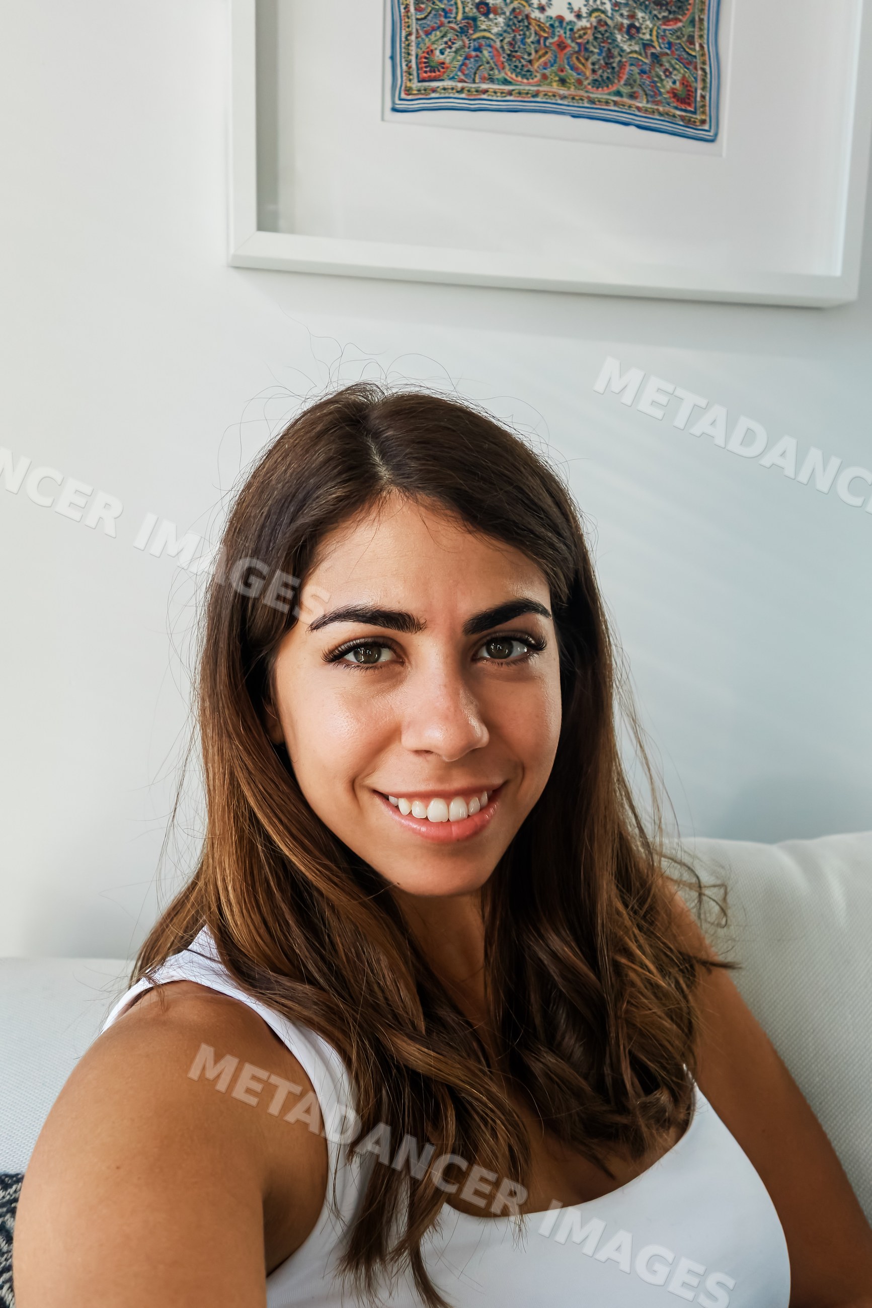 A young white woman smiling inside a modern icelandic home