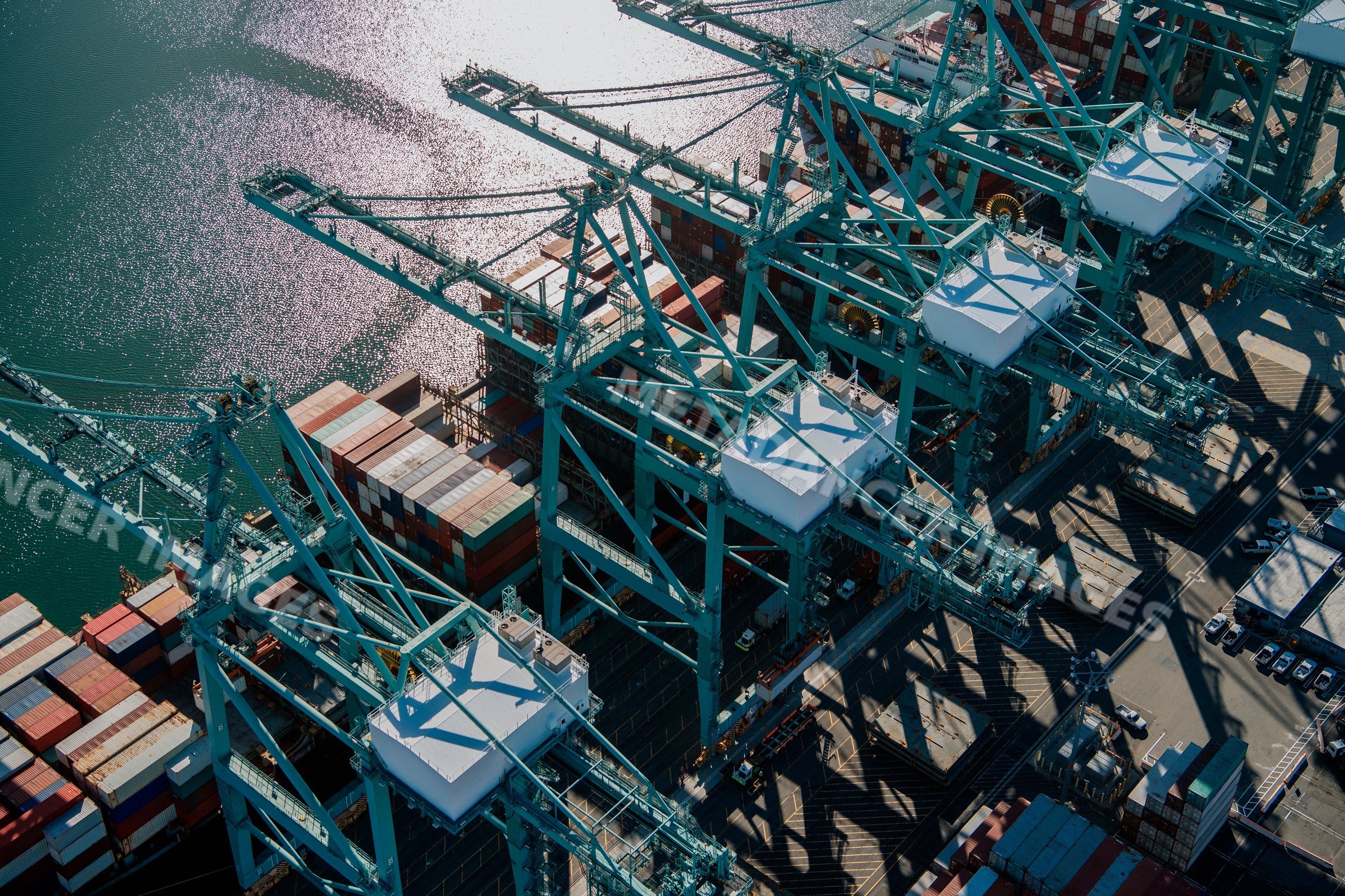 Container cranes loading cargo ship in a beach
