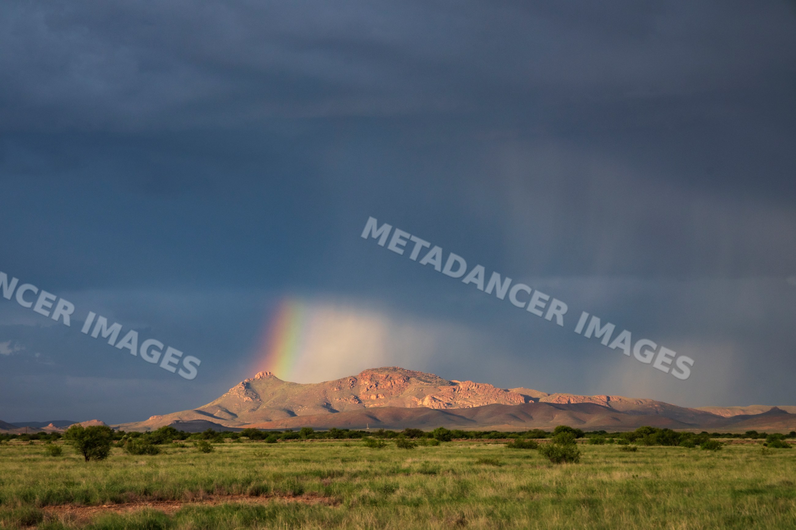Rain Shafts and Rainbow over Arizona mountains
