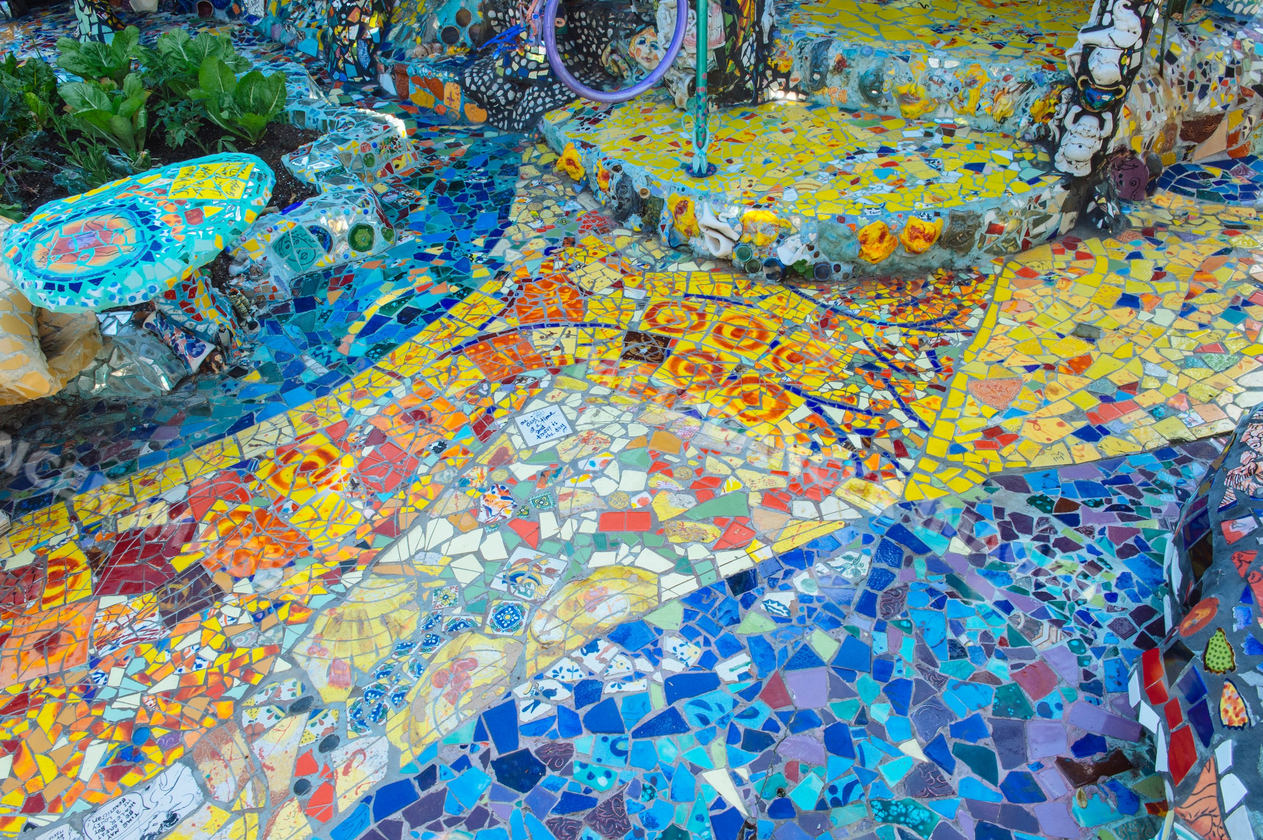 Colorful outdoor mosaic tile art in garden setting