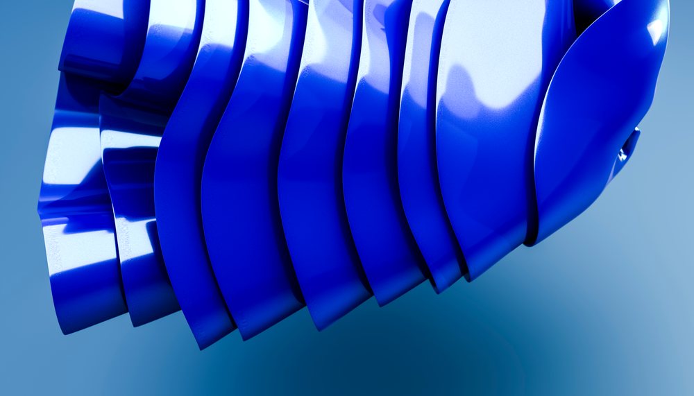 Blue abstract sculpture with layered curved glossy forms in studio