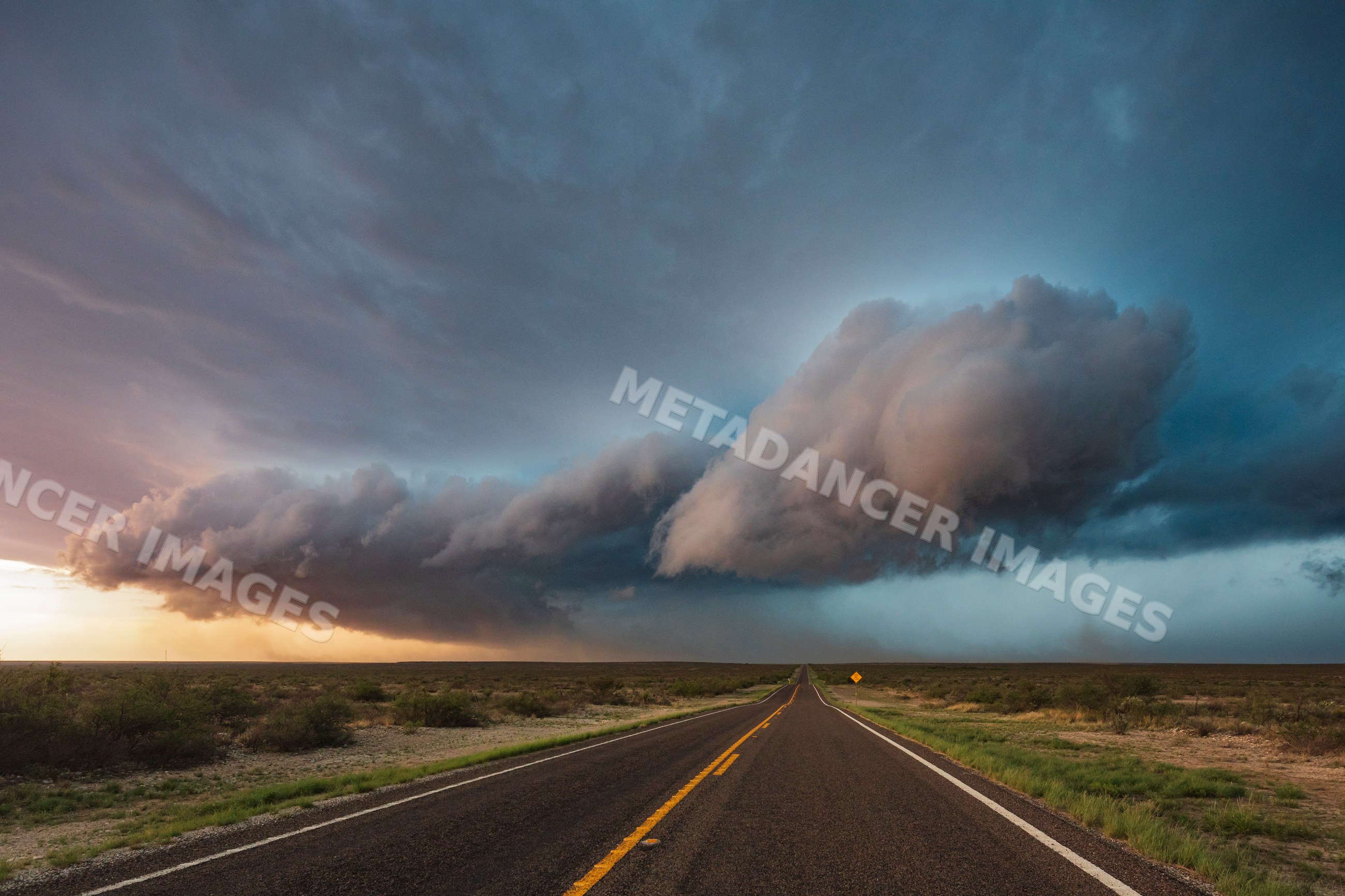 Supercell storm forming over open road in sanderson