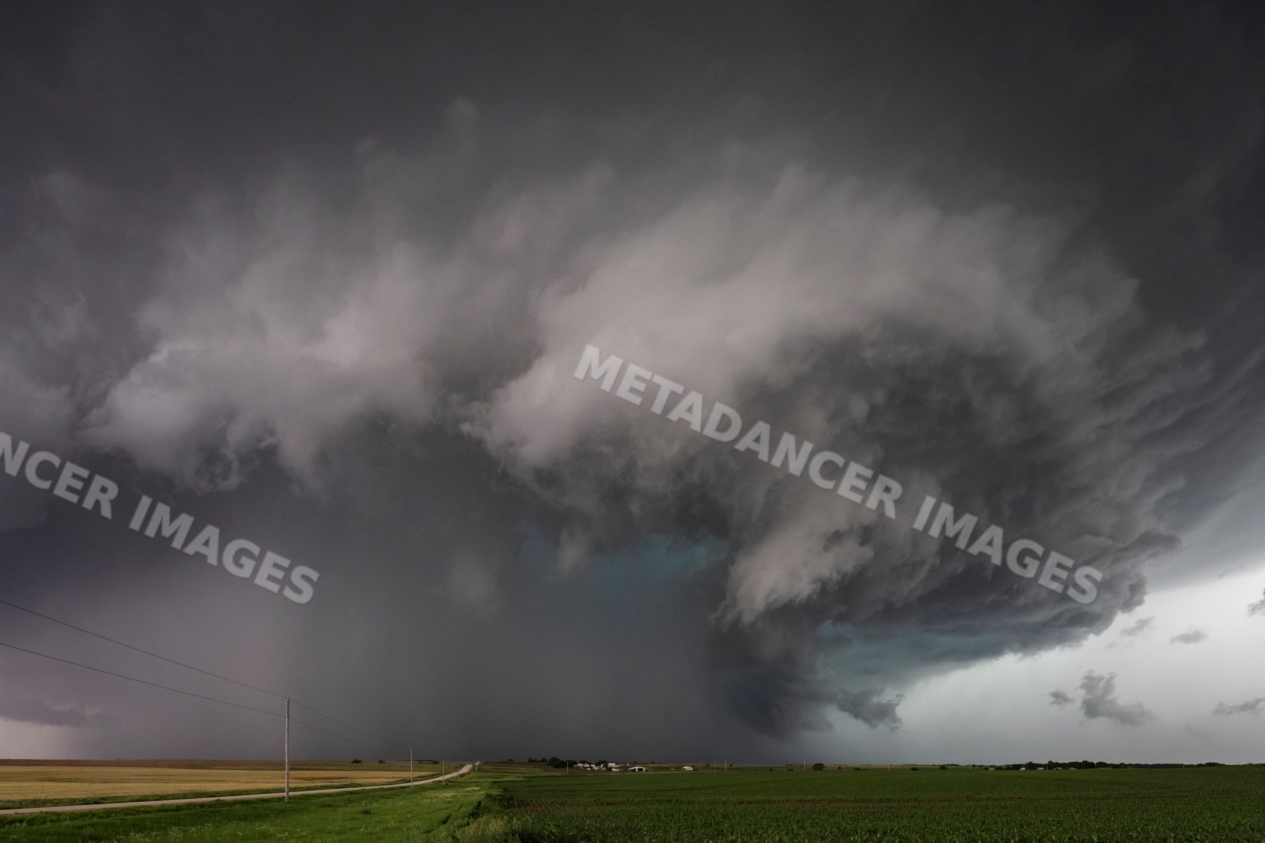 Supercell storm forming over agricultural fields near enterprise