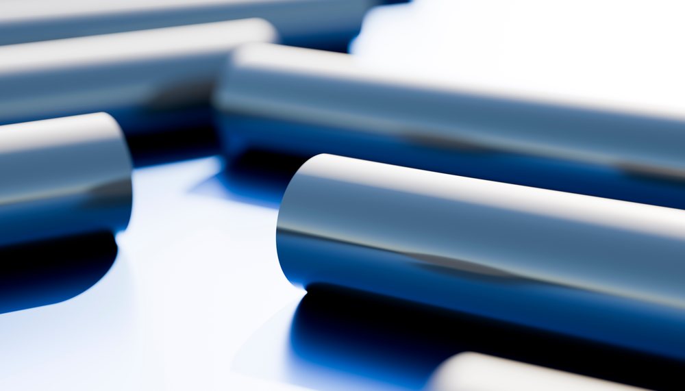 Blue metal tubes with reflective surface in an industrial setting