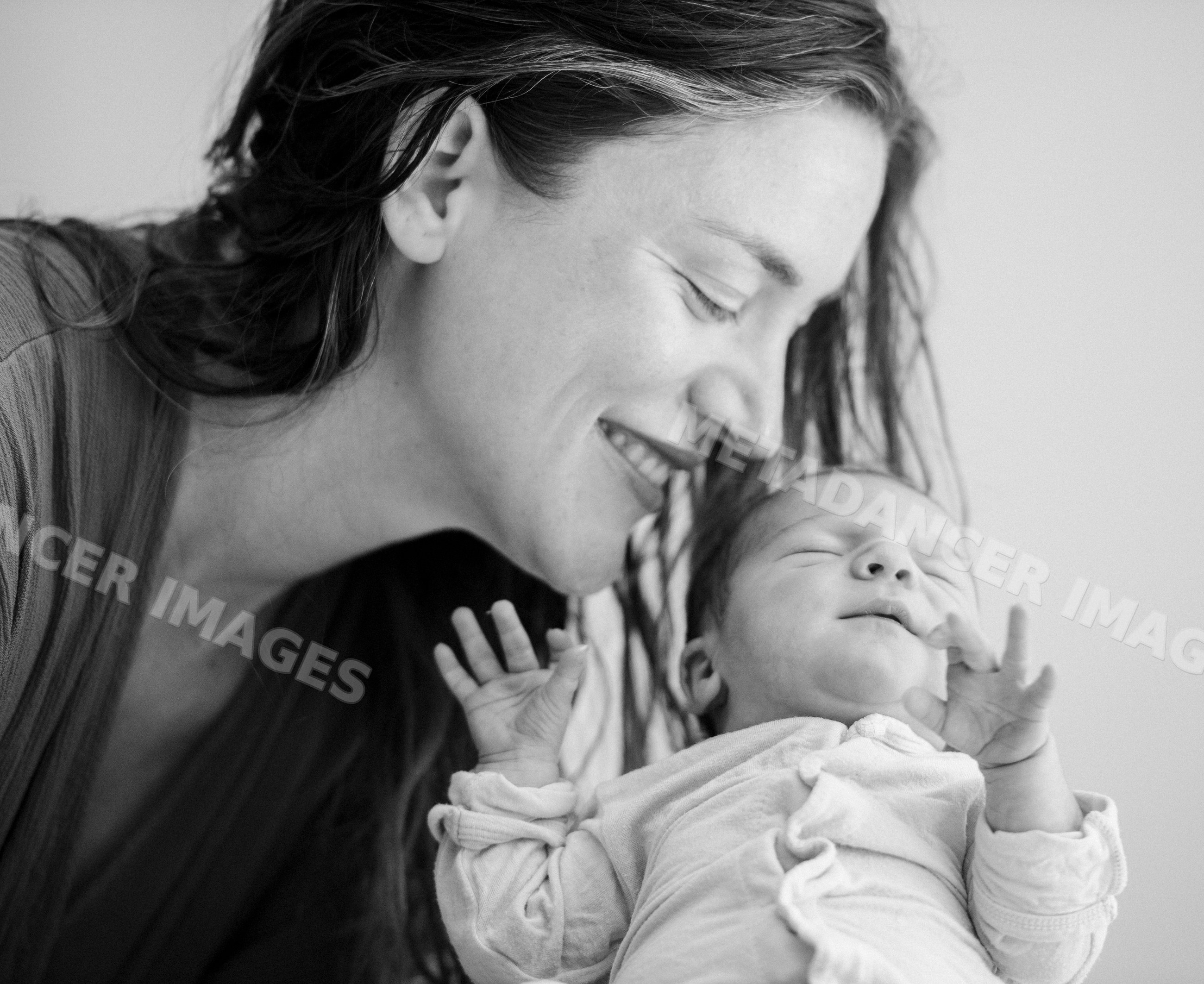 Mother holding newborn baby in tender bonding moment
