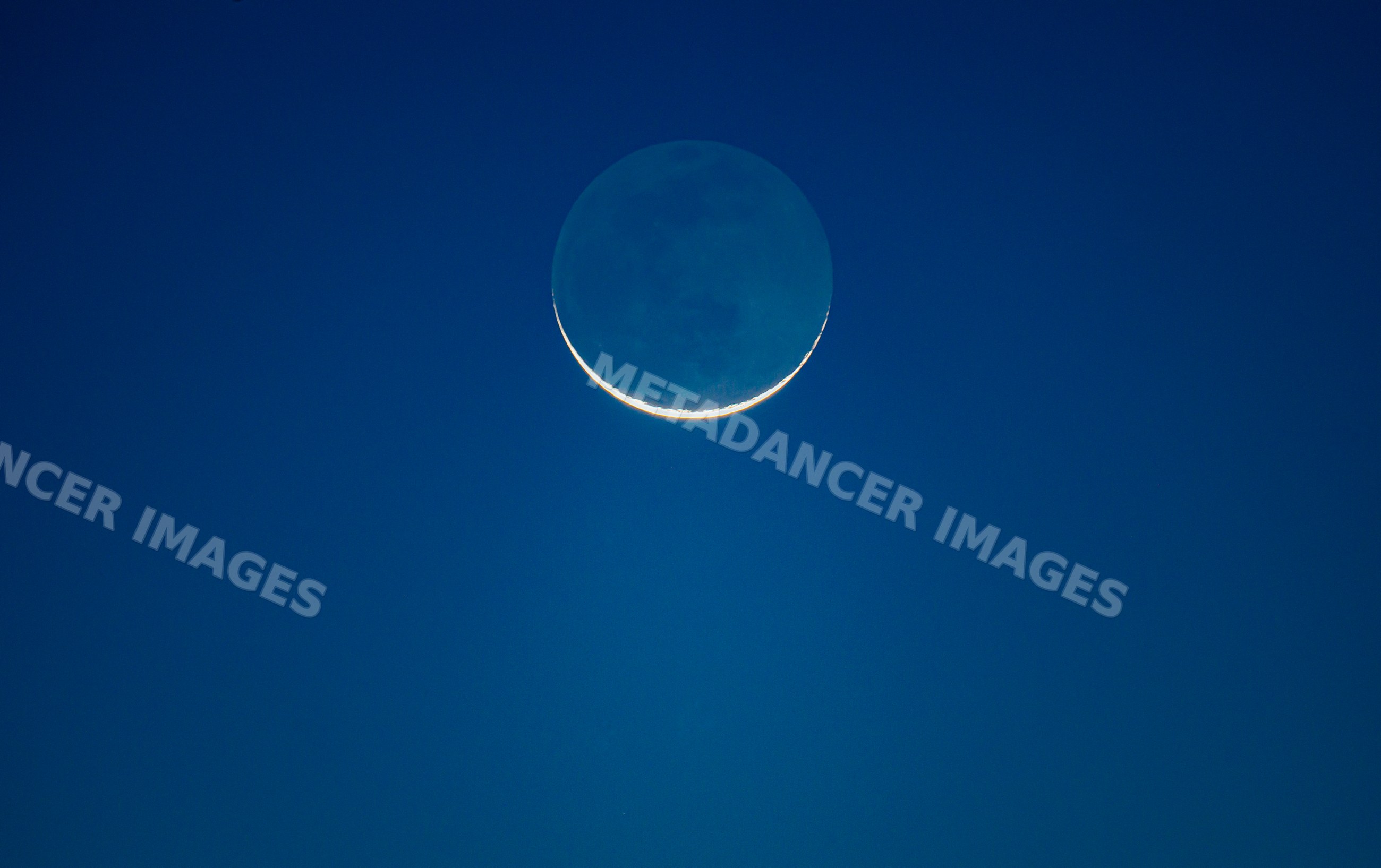 Crescent moon with visible lunar surface