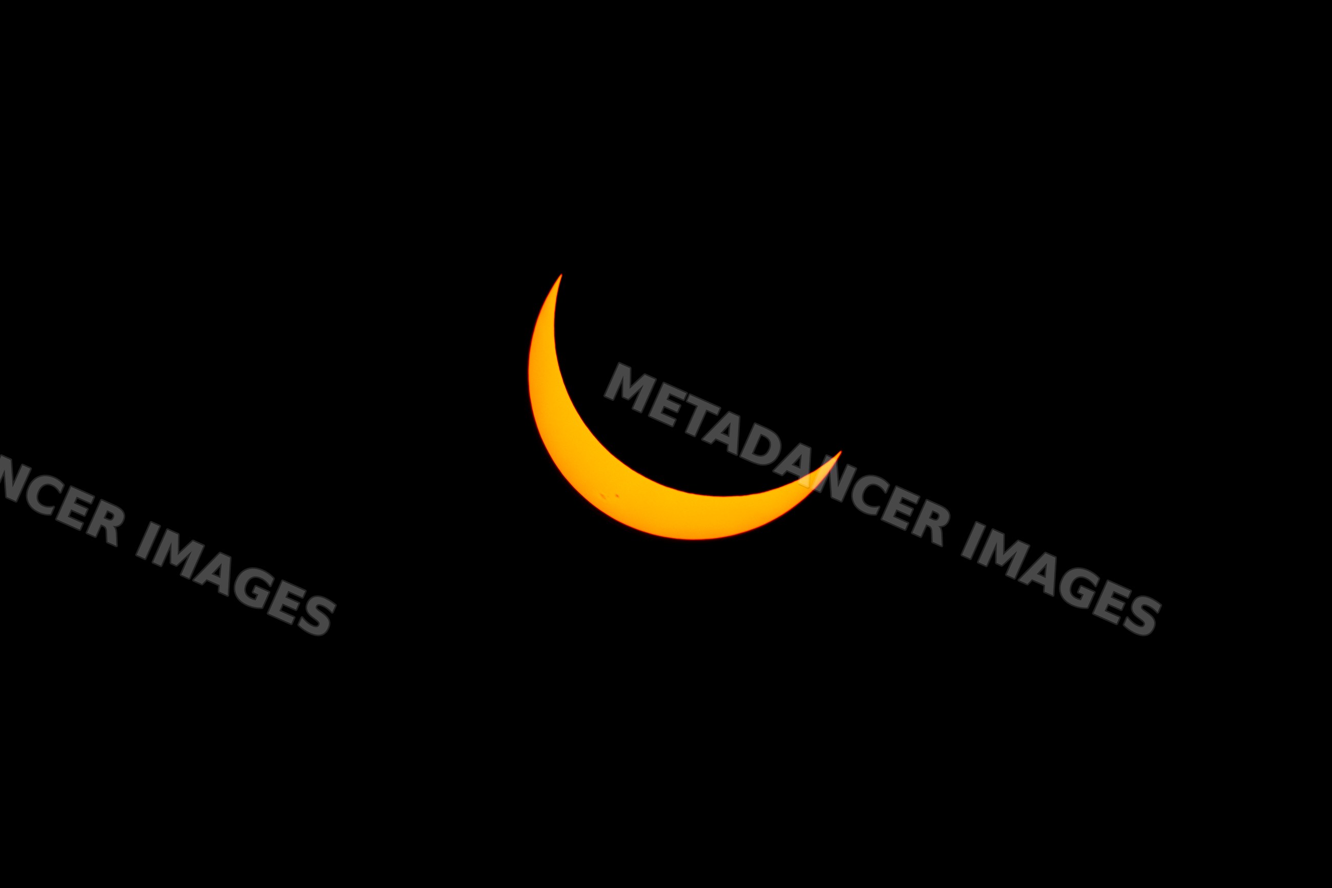 Solar eclipse crescent sun over Los Angeles sky