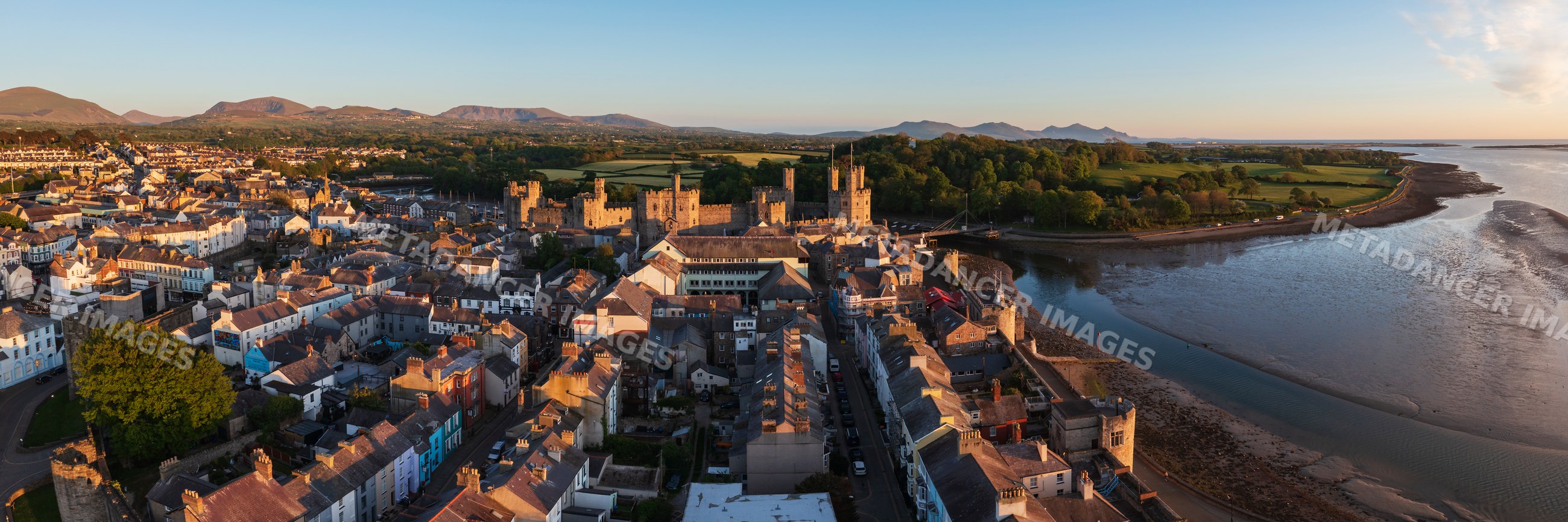 Aerial view of Caernarfon town and castle at Sunset in Wales